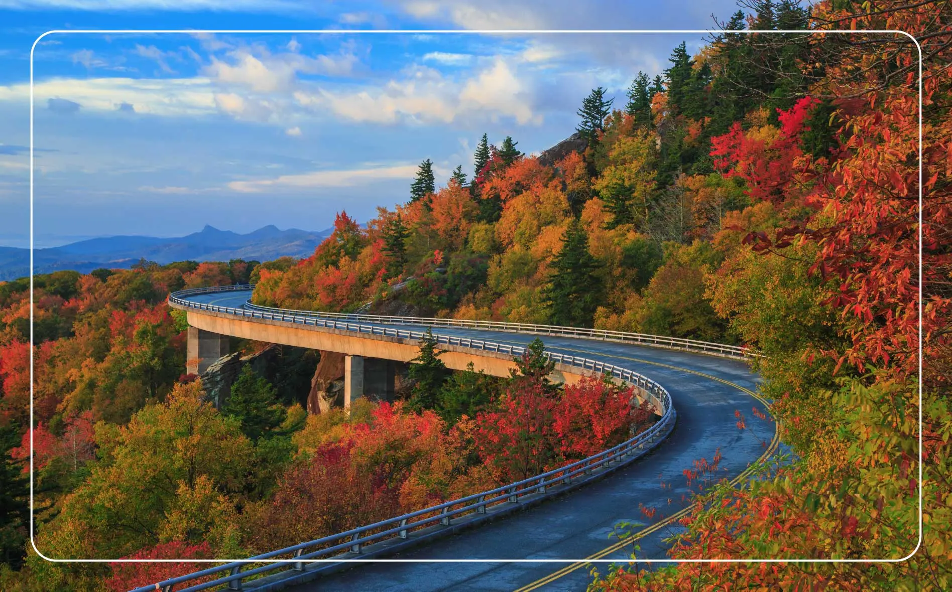 Road winding through the mountains with autumn colors along the Blue Ridge Parkway.
