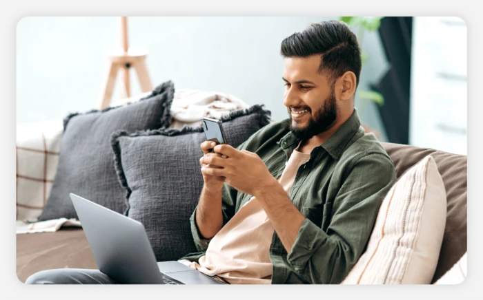 Man looking on his phone for cheap baseball tickets 