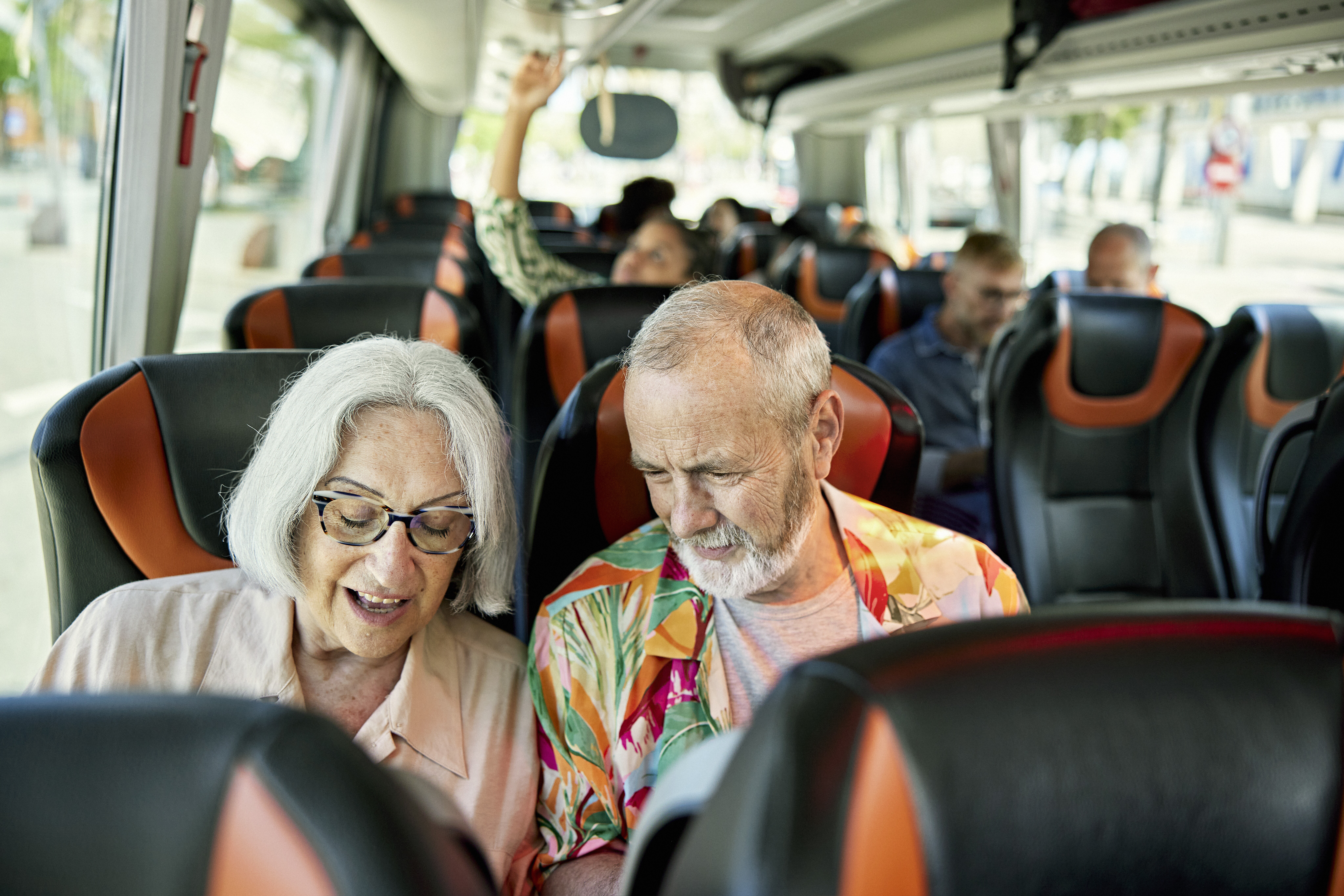 Image of a senior couple on a bus tour.
