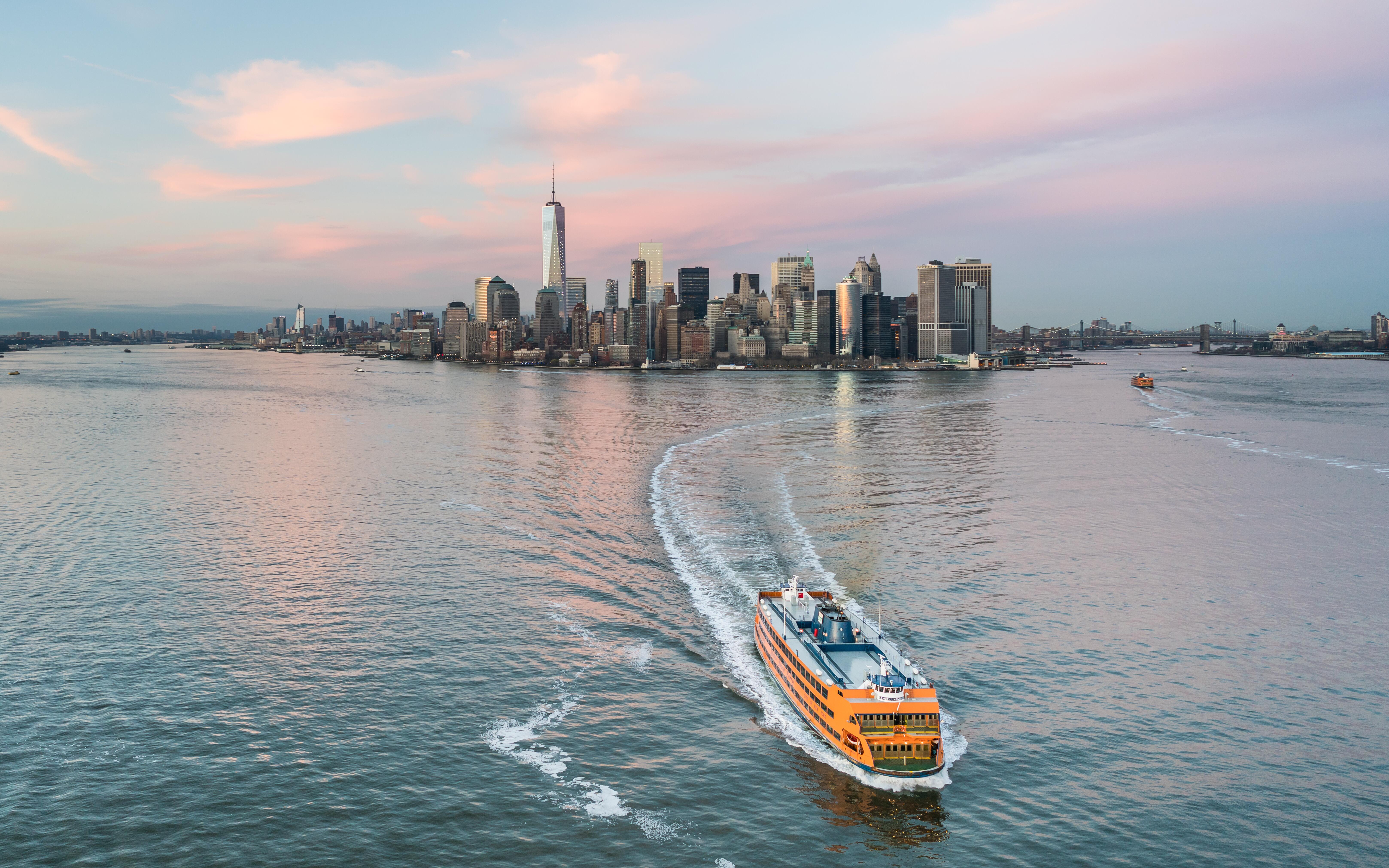 Image of the New York City Staten Island Ferry sailing in front of the city skyline.