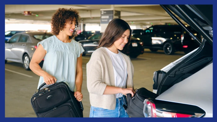 Two passengers loading up their vehicle with their luggage ahead of their flight.