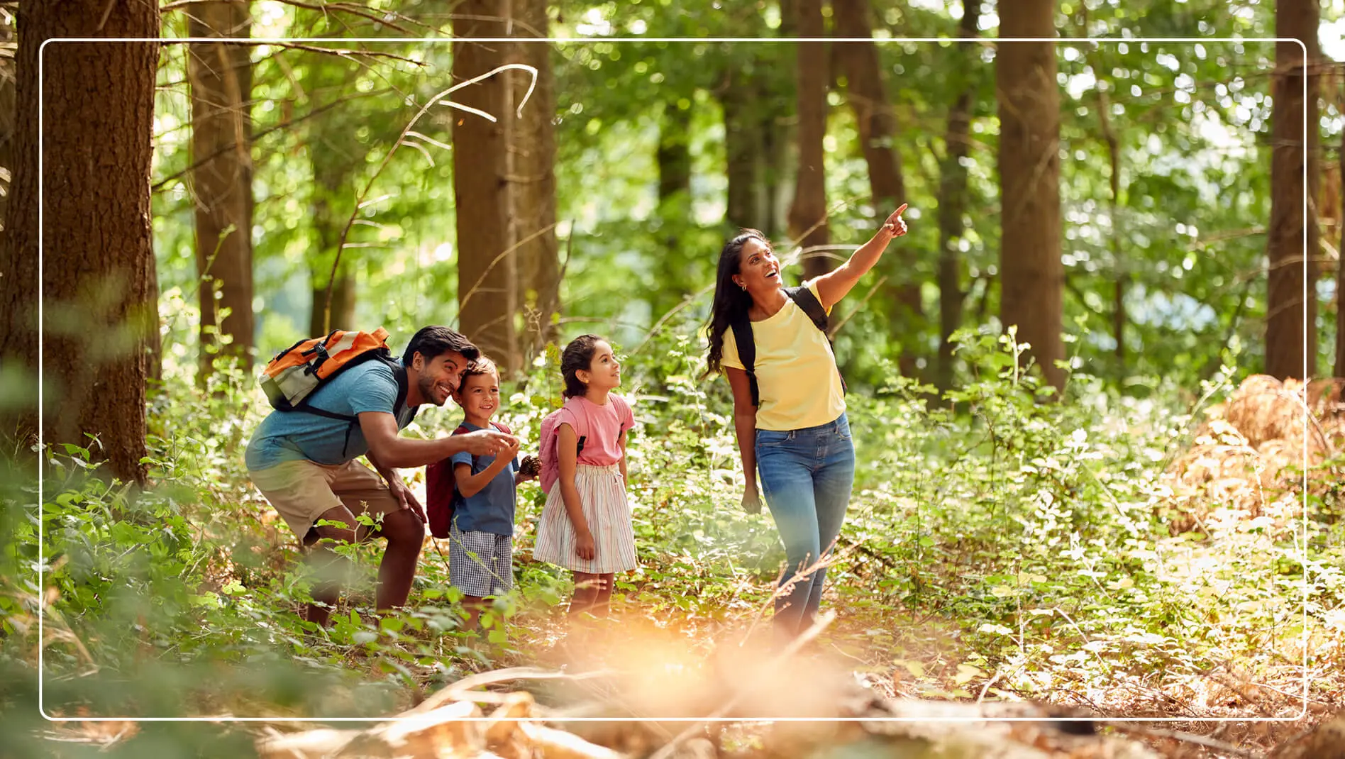 A family out on a hike in the forest.
