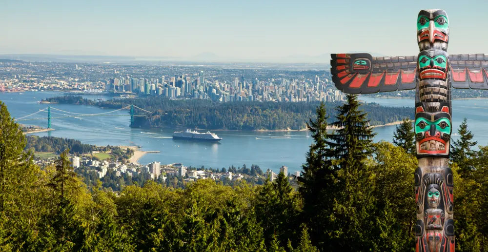 Scenic view of a cruise boat and totem pole in Vancouver British Columbia