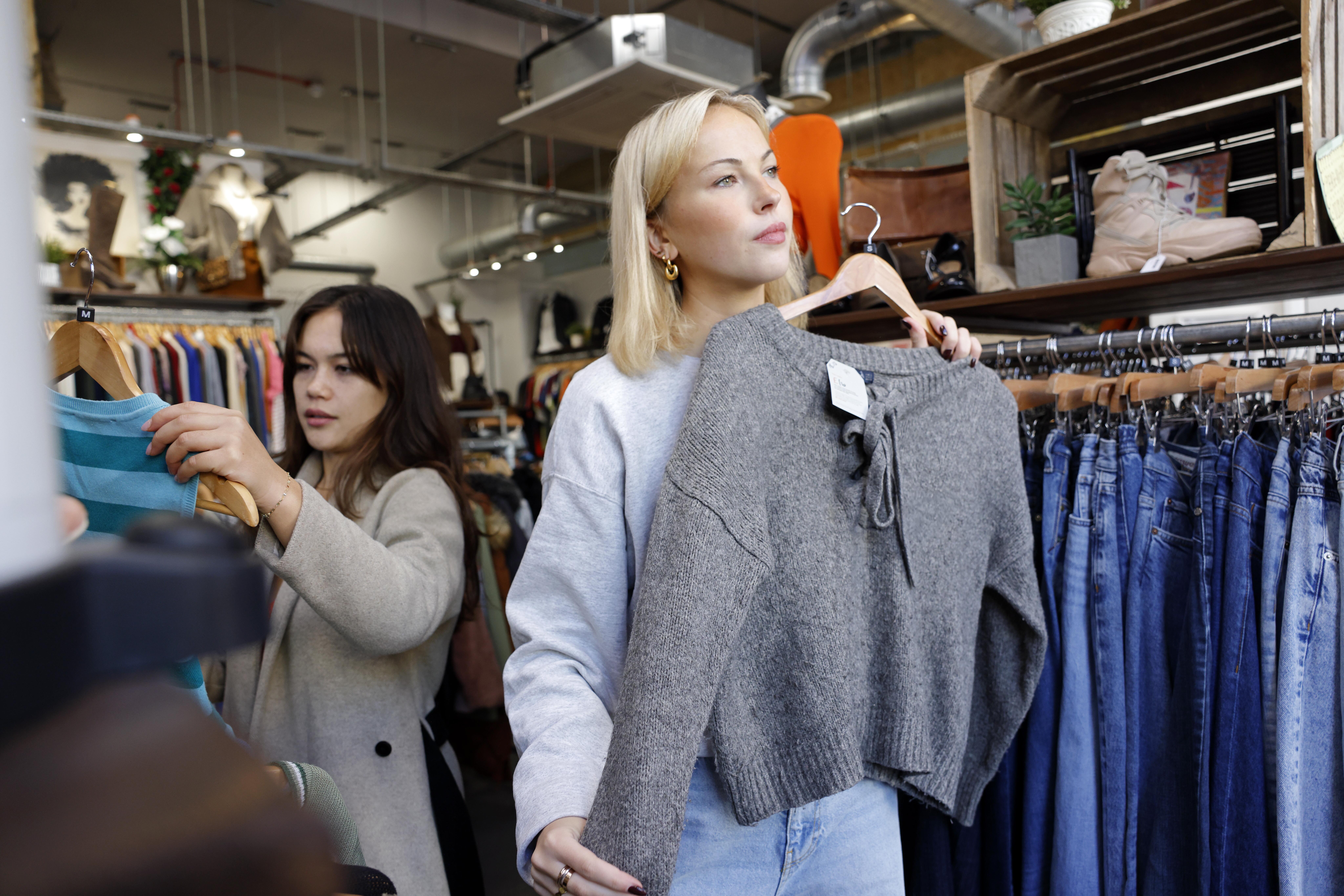 Image of two women shopping at an indoor clothing store.