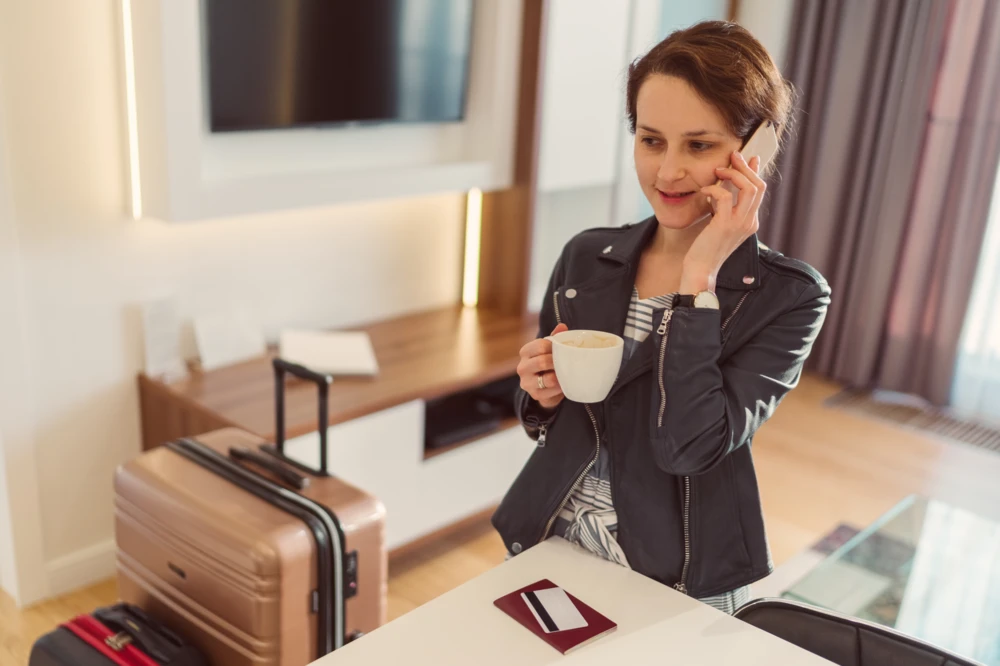 Girl making a cell phone call from hotel room