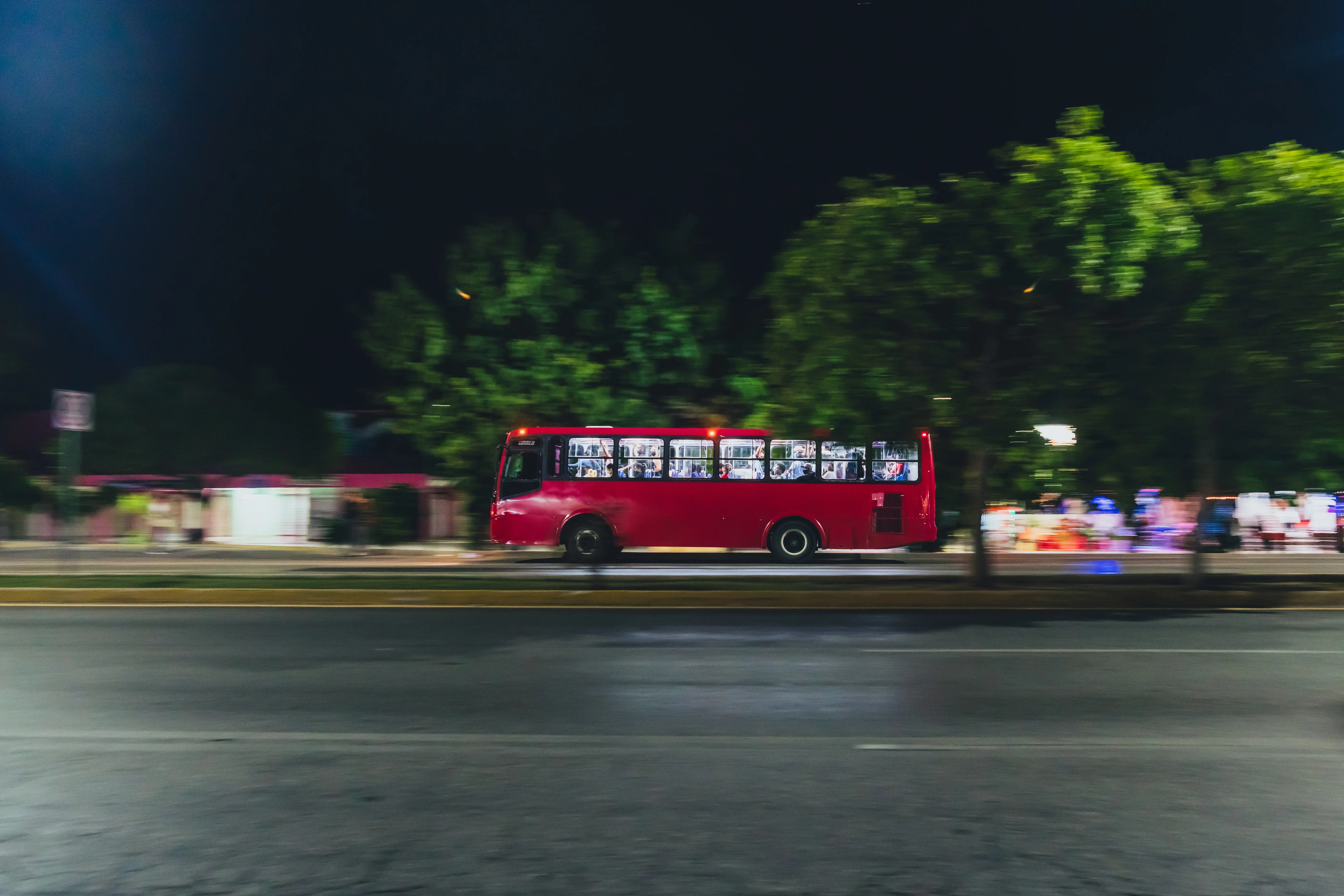 Motion of City Bus travelling through Streets at night in Cancún, Mexico