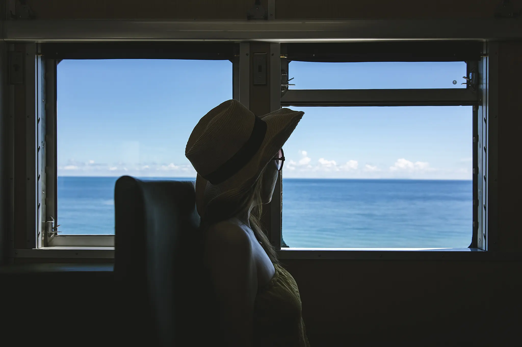 Image of a woman looking out the window on a train.