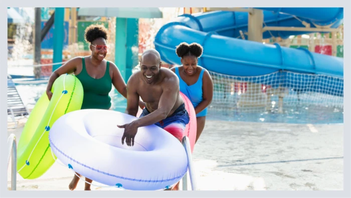 A family is shown having fun together at a waterpark, capturing another fun experience gift idea. 