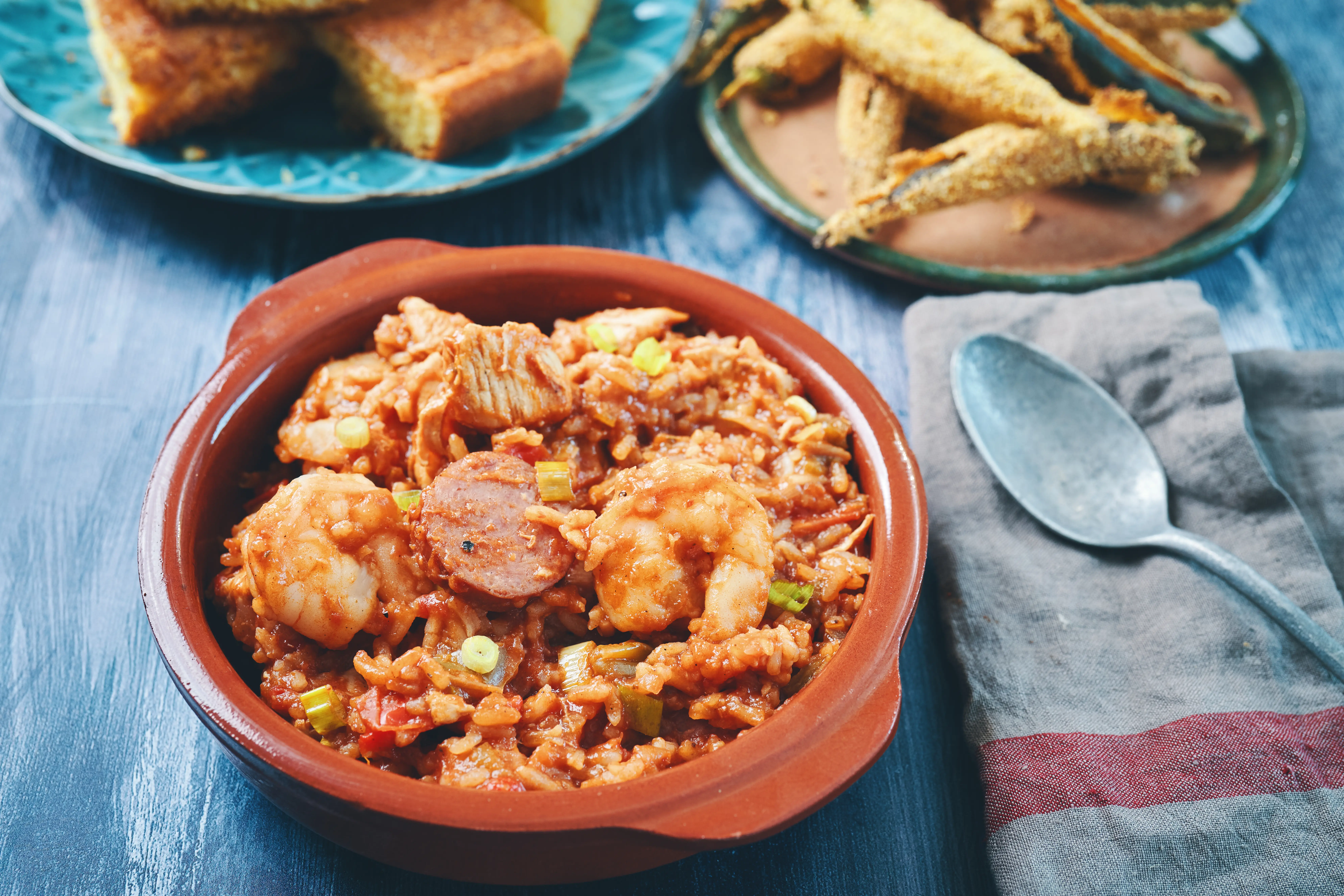Image of a dish of Cajun-style chicken and sausage jambalaya in a cast iron pot.