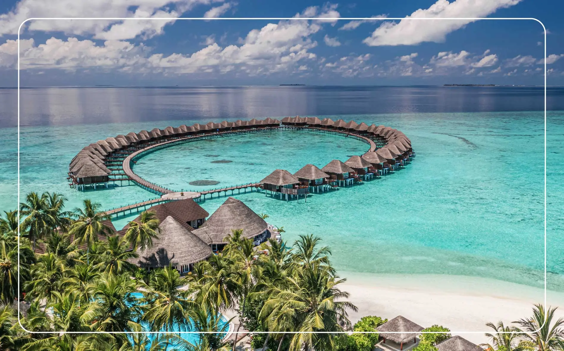 Aerial of over water bungalow villas in the tropical island paradise of the Maldives.