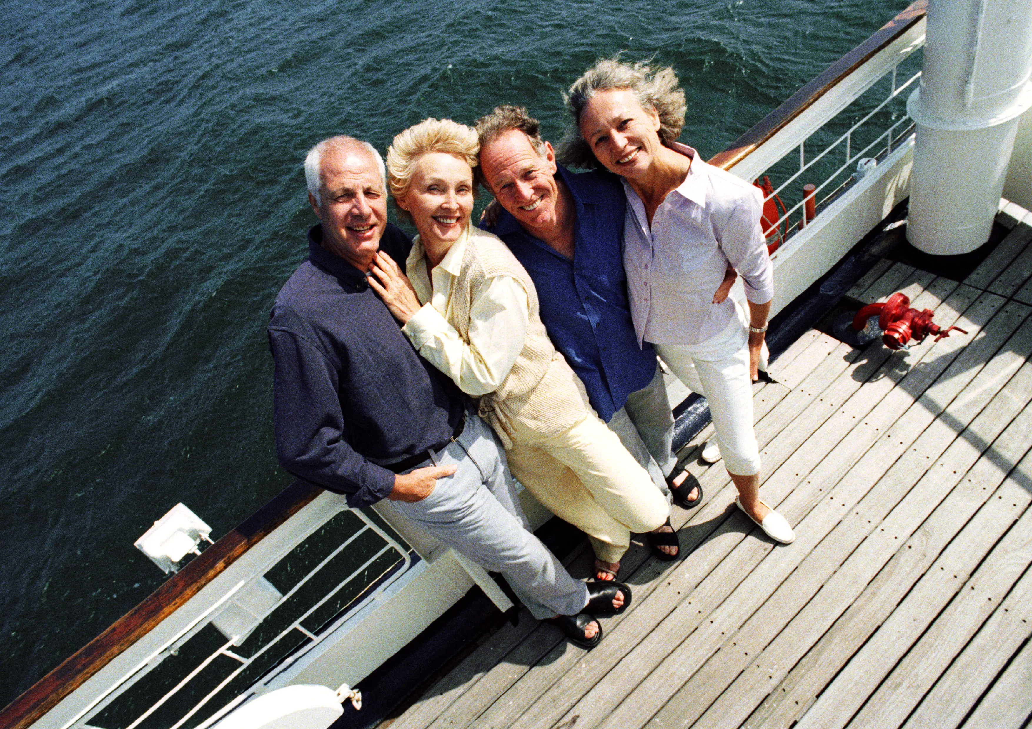 Image of two senior couples standing on the deck of a cruise ship.