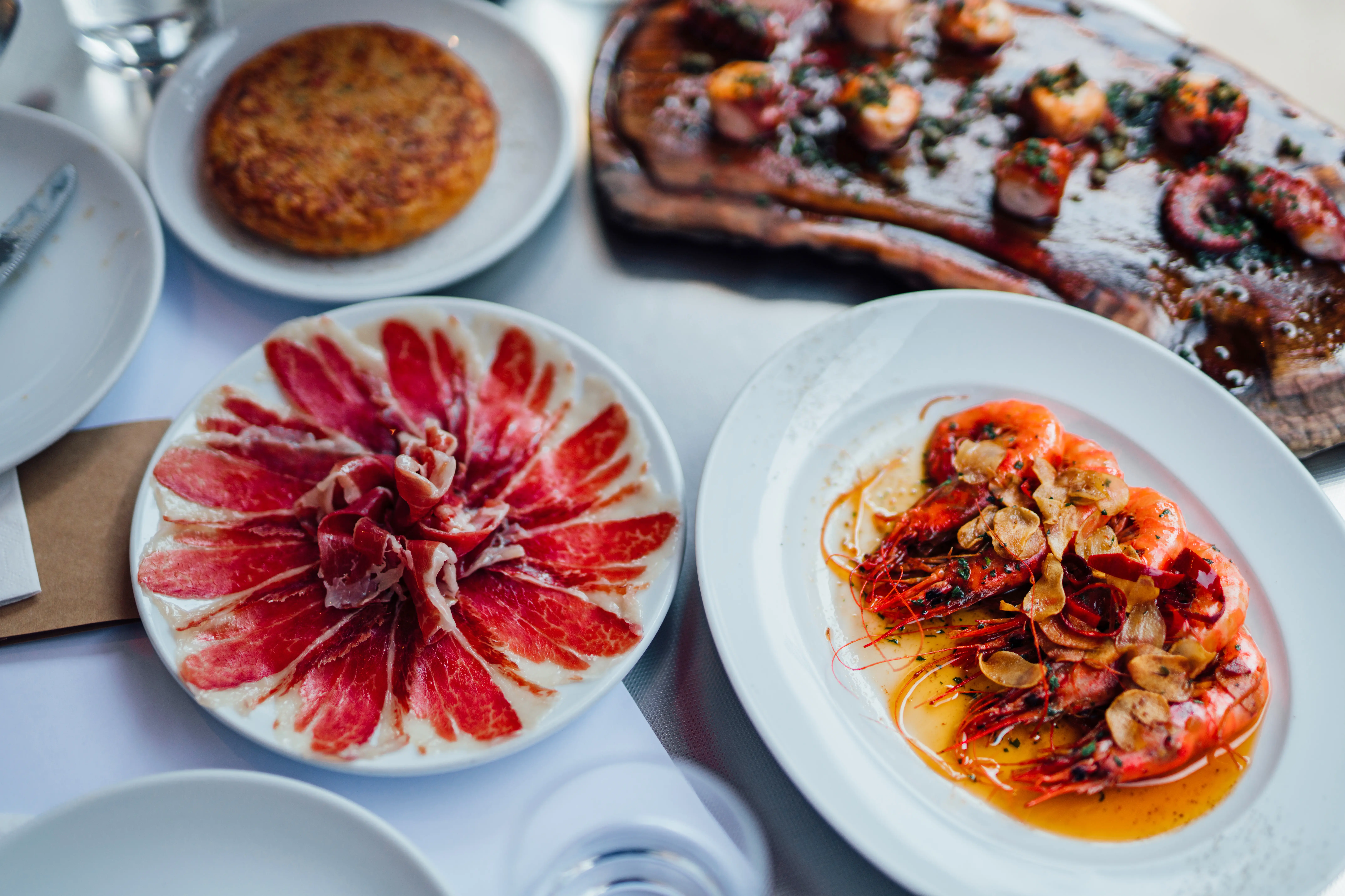 Tapas brunch with Ibérico jamón, polbo a feira, gambas à la plancha, and tortilla
