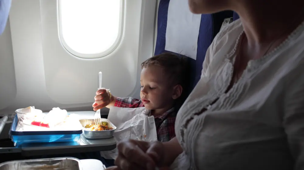 Baby eating on airplane