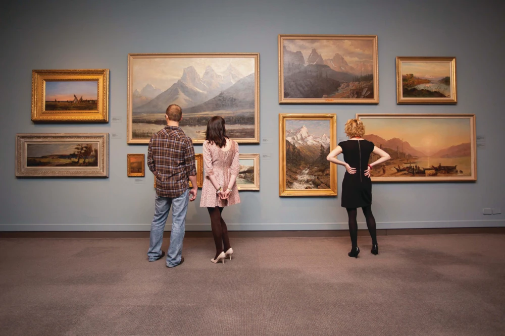 Visitors viewing paintings at the Glenbow Museum.