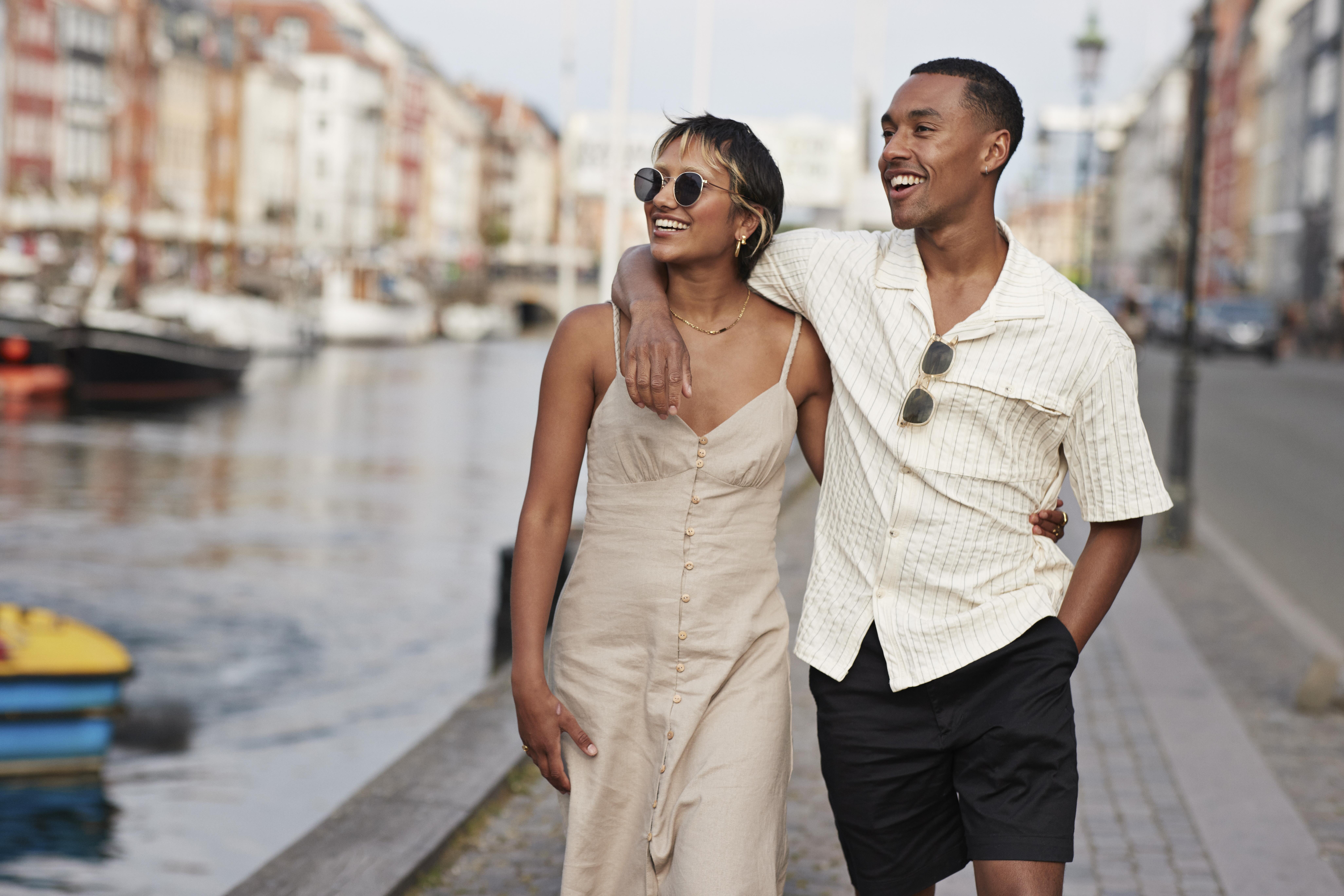 Photo of a couple walking on the waterfront in Copenhagen, Denmark