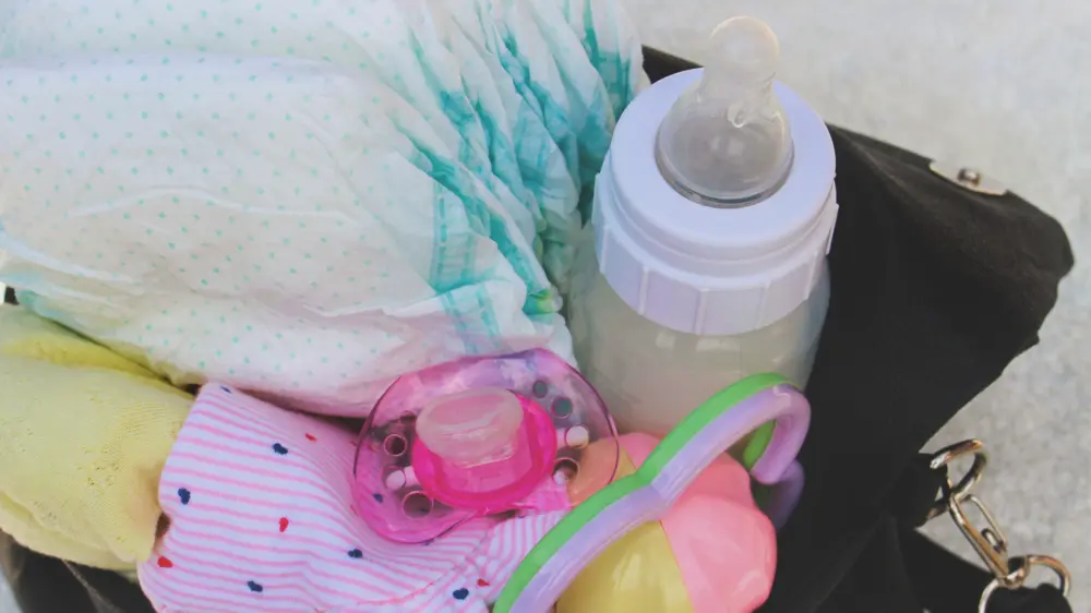 Packing baby items including bottle and pacifier