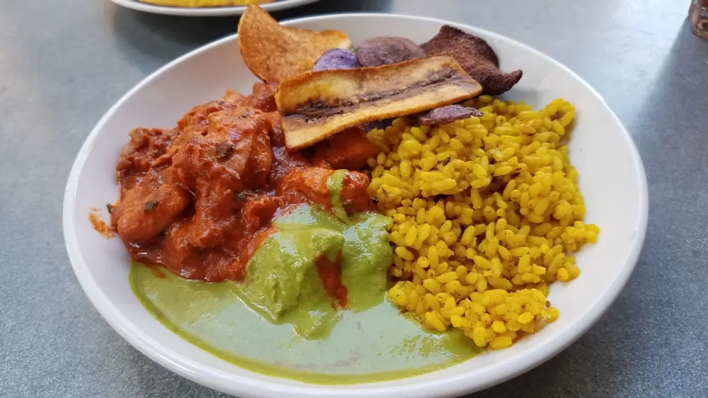 Butter chicken and tumeric rice at Pondicheri in Houston.