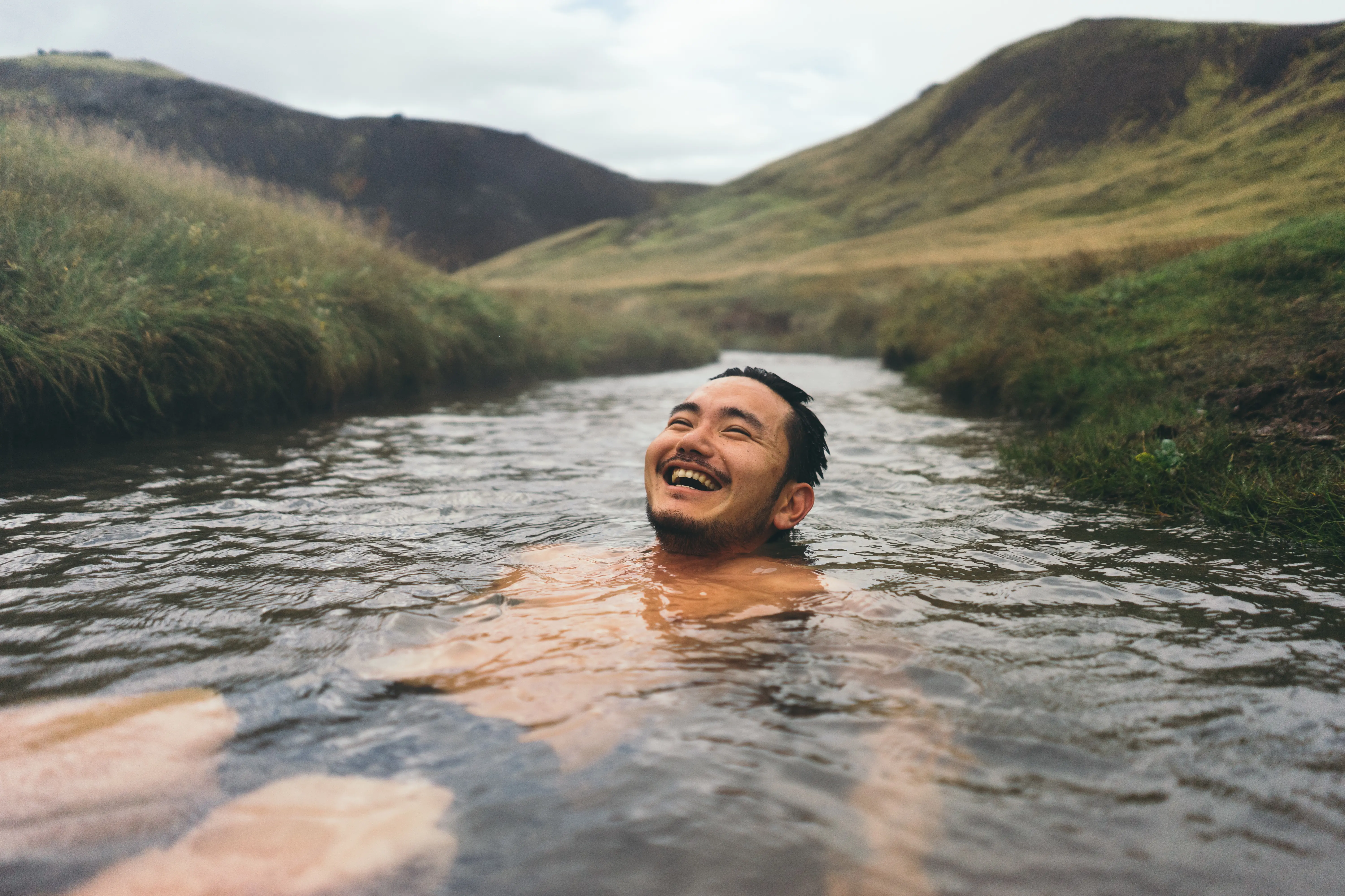 Photo of man swimming in Iceland hot springs