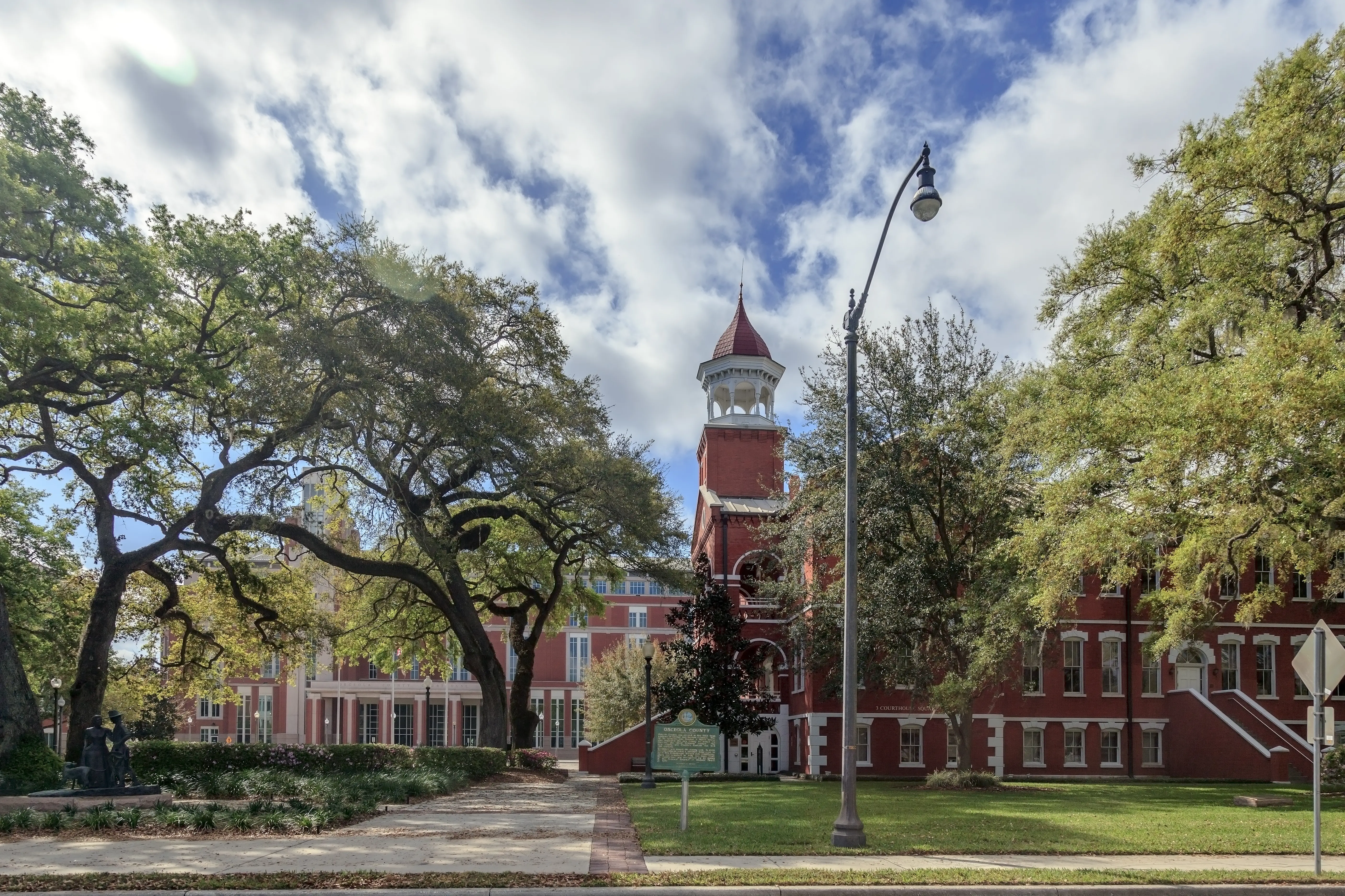 This beautiful setting in Kissimmee Florida shows the original Courthouse in the foreground and the new, modern courthouse behind - illustrating the perfect "old meets new" blending of the architecture.