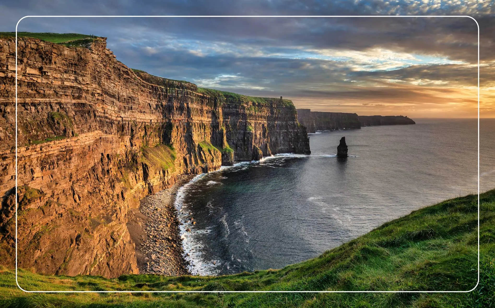 Sunshine illuminates the coastline along the Cliffs of Moher in County Clare, Ireland.