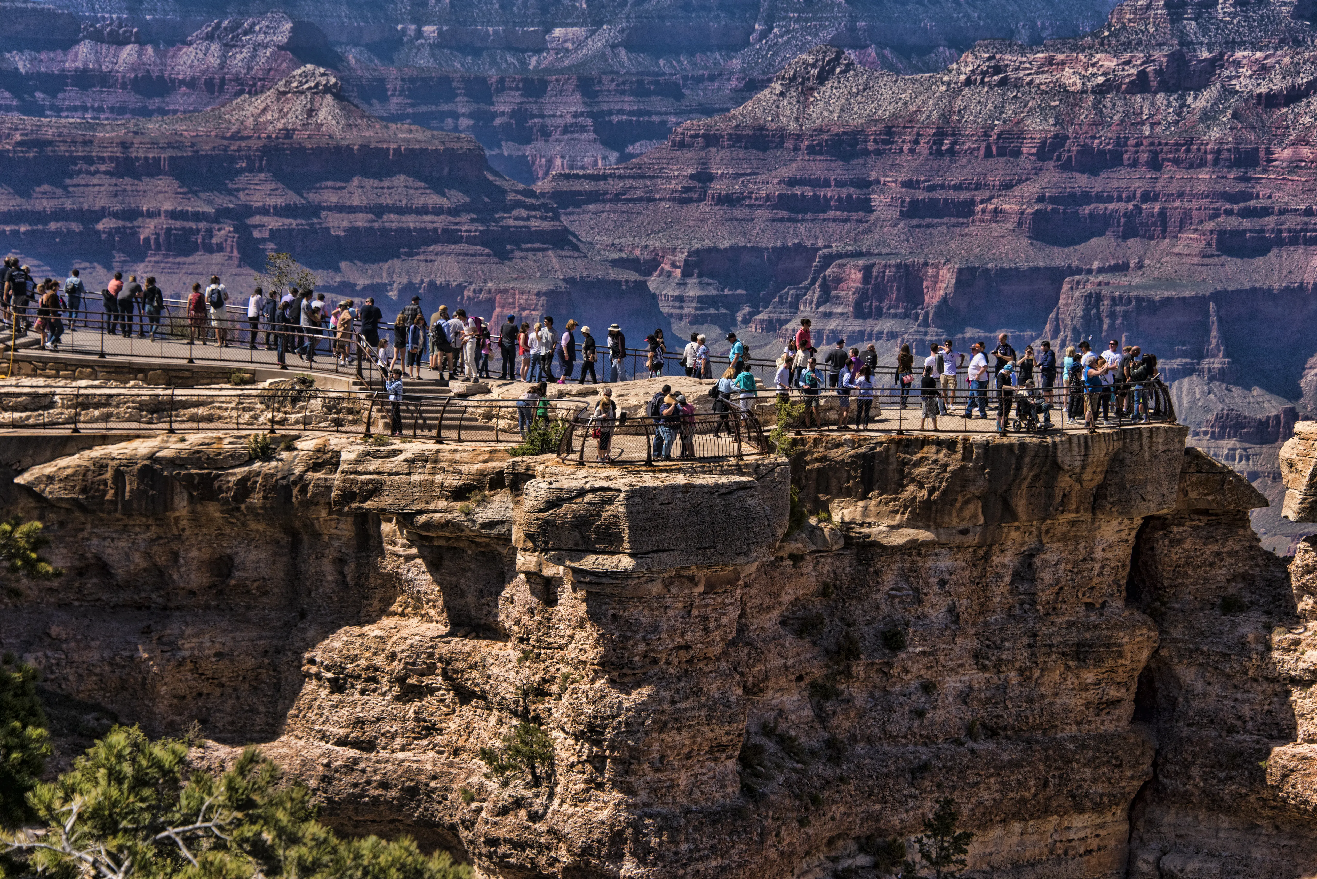 Image of people exploring the trails and expansive views of the south rim of the Grand Canyon.