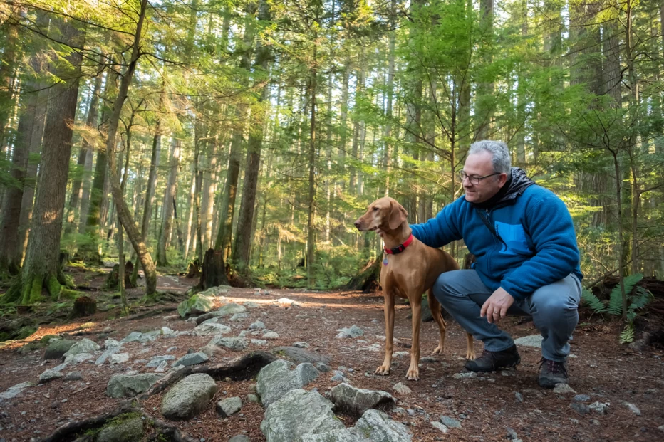 Man and dog hiking in a forest