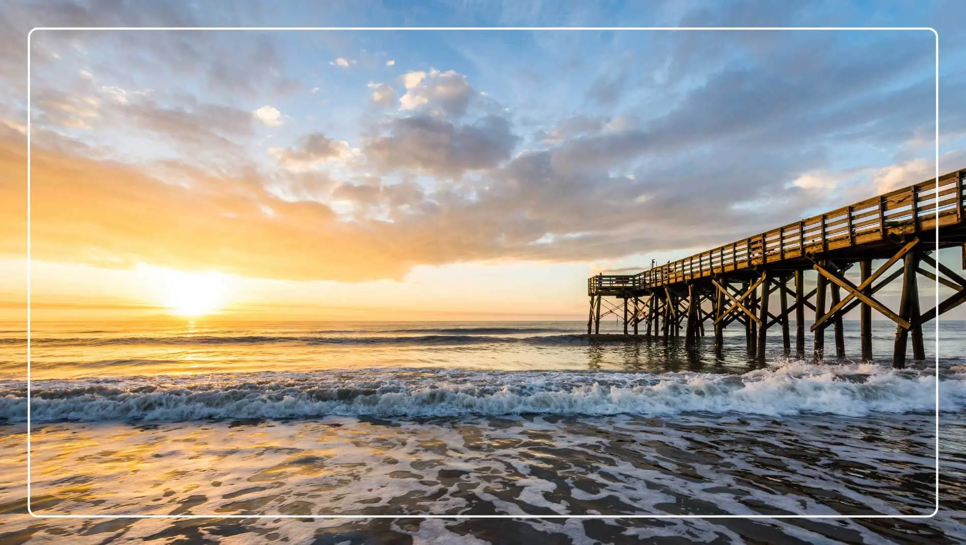 The ocean and pier at sunset in Isle of Palms, South Carolina.