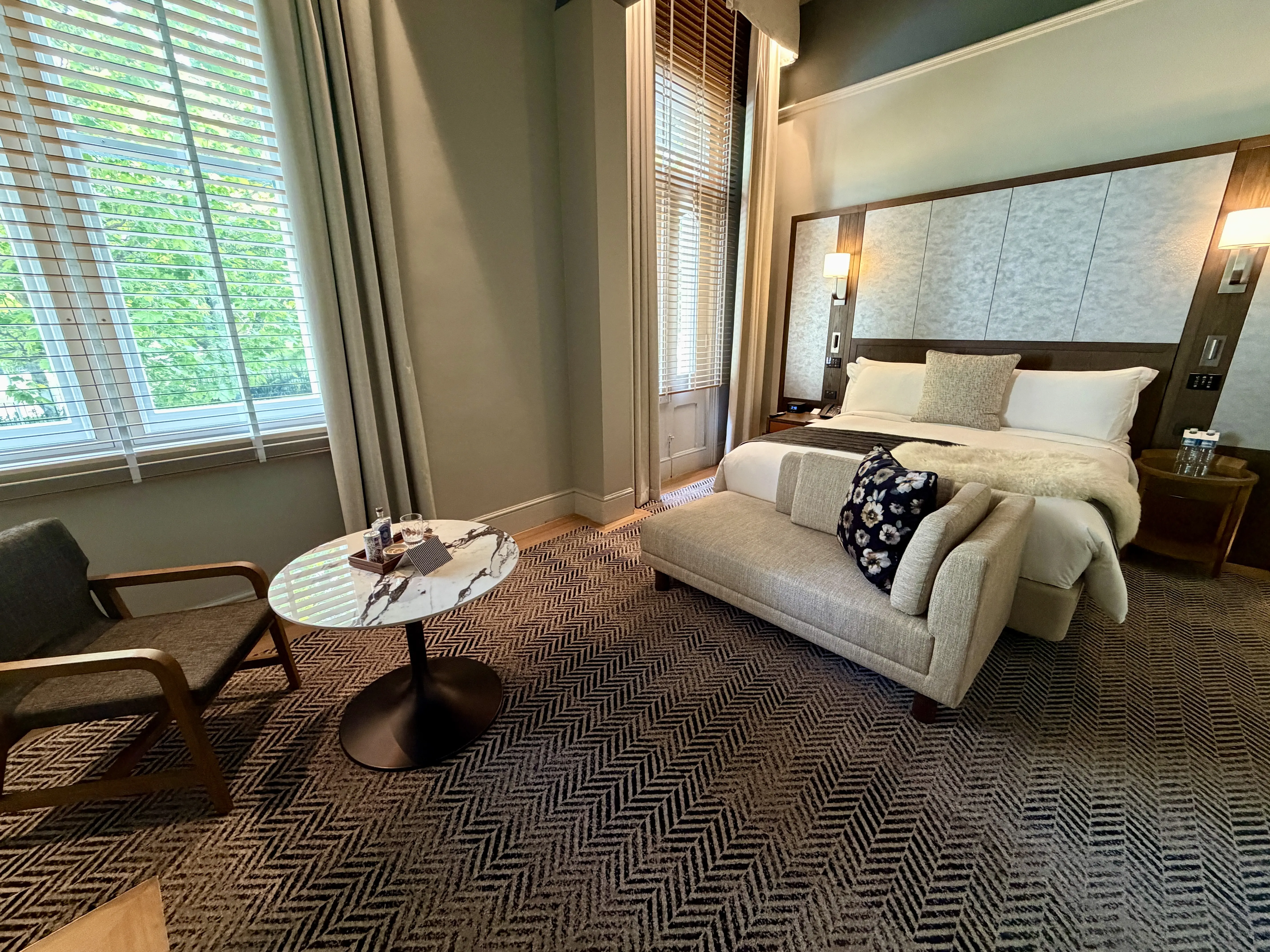 hotel room with bed and modest sitting area