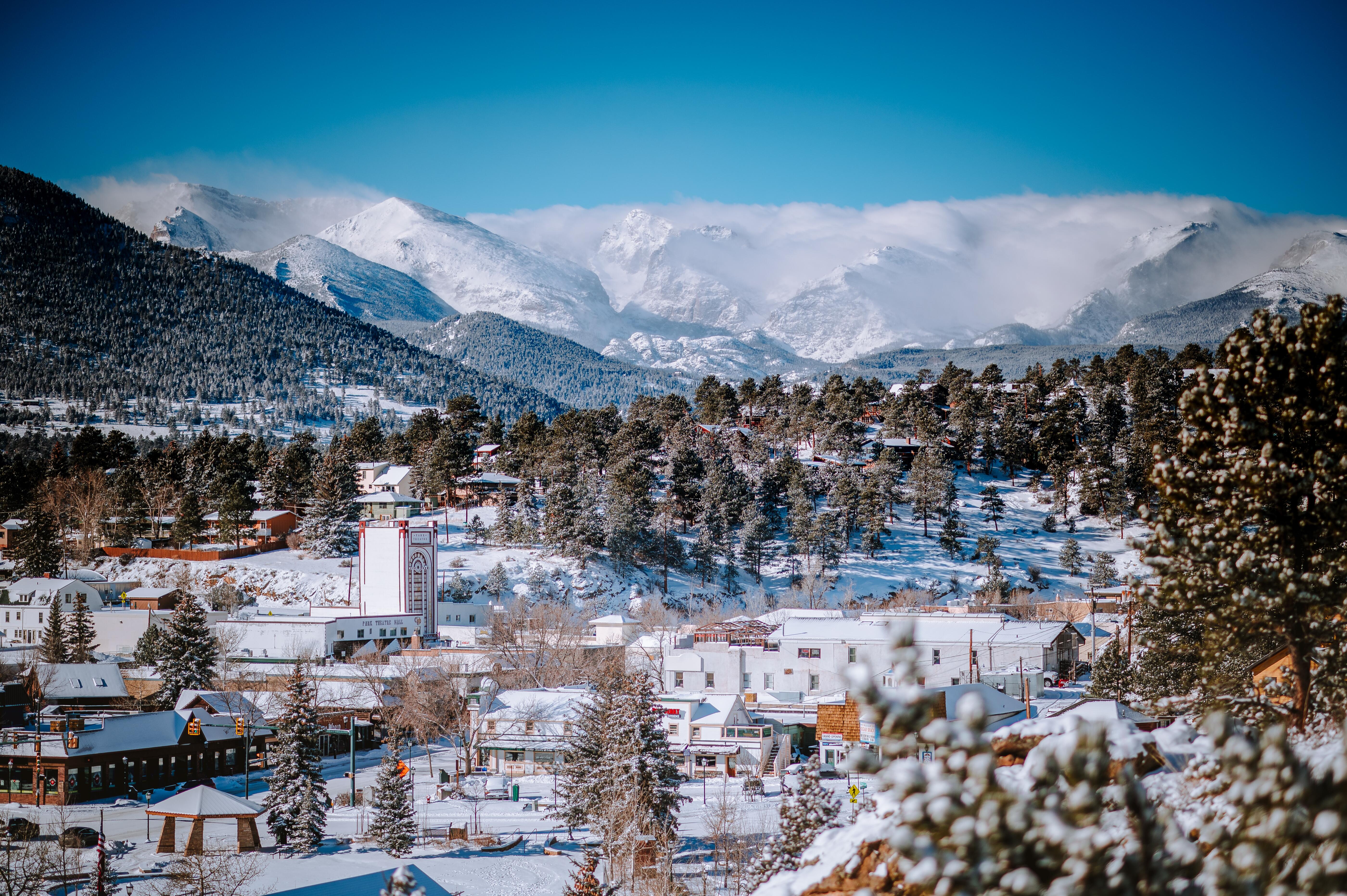 Sky view of snow-coverd Estes Park, Colorado with mountains in the background