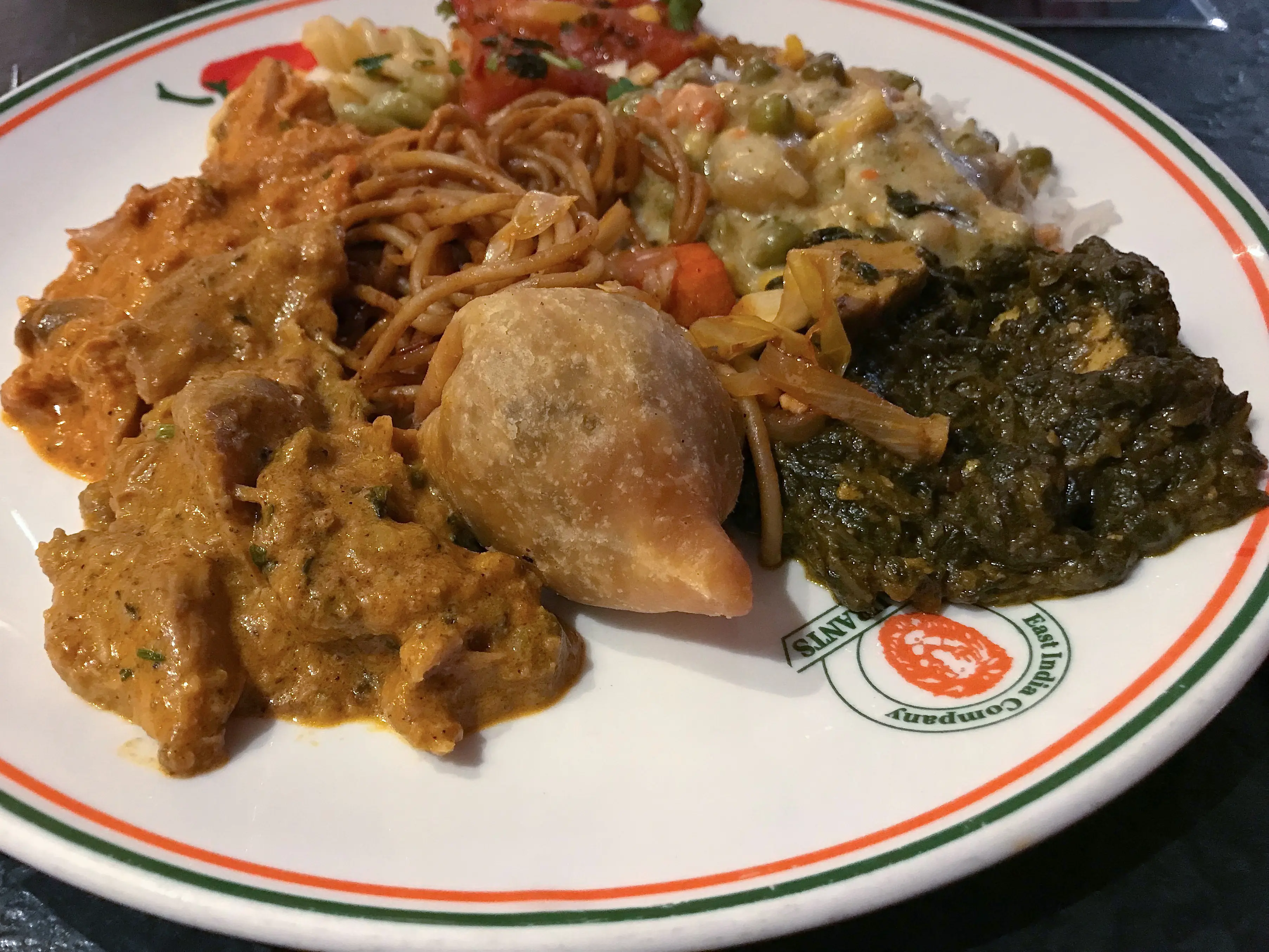 Plate of various authentic Indian foods at East India Company Pub & Eatery in Winnipeg, Manitoba.