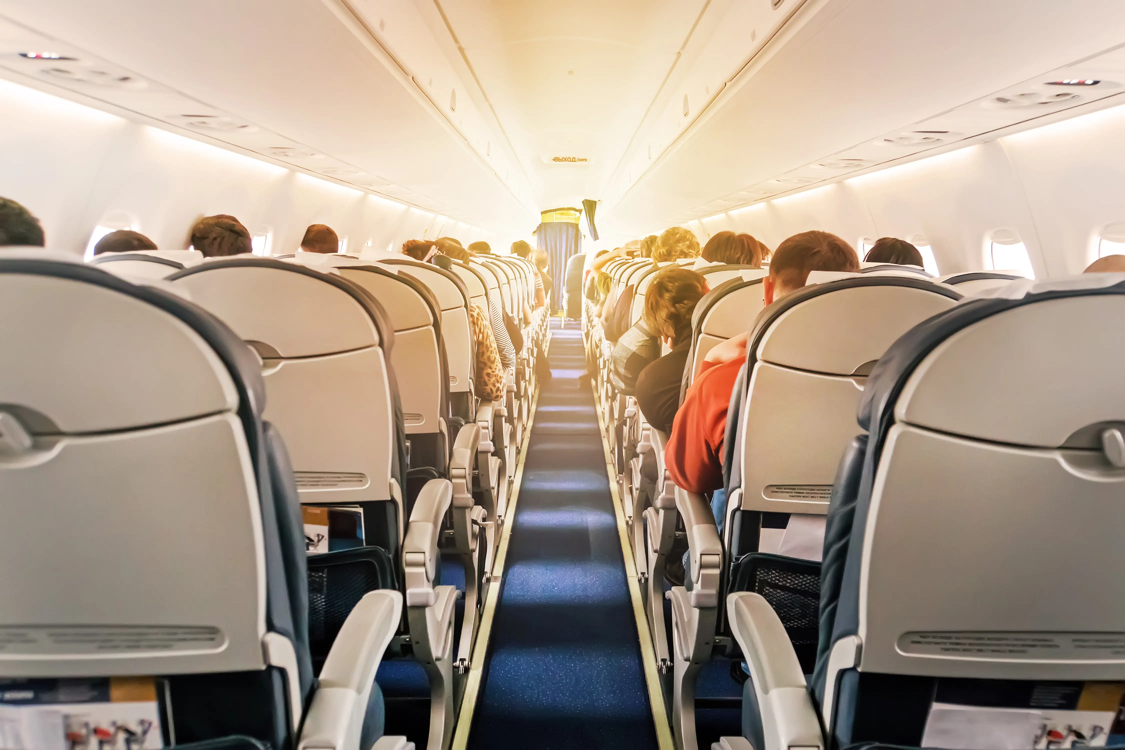 Aisle of seats on an airline flight.