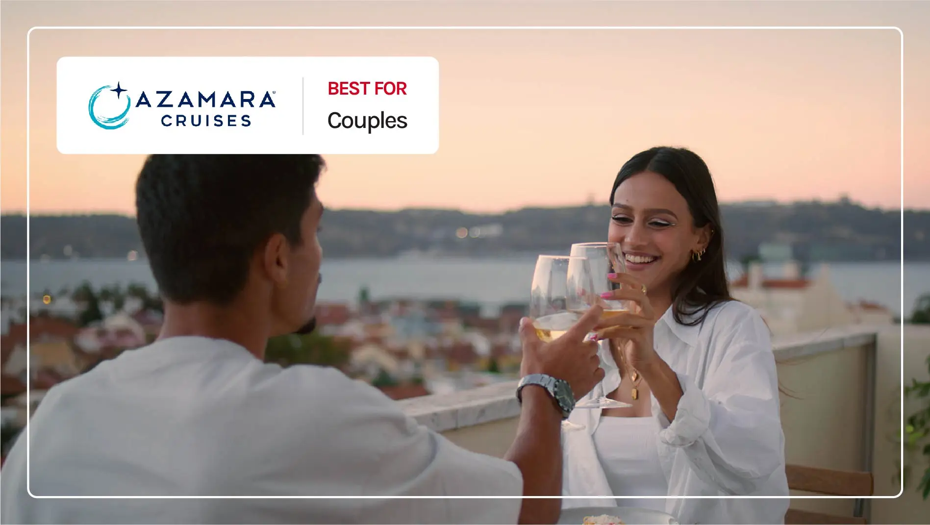 A couple drinking wine on a balcony in the Mediterranean.