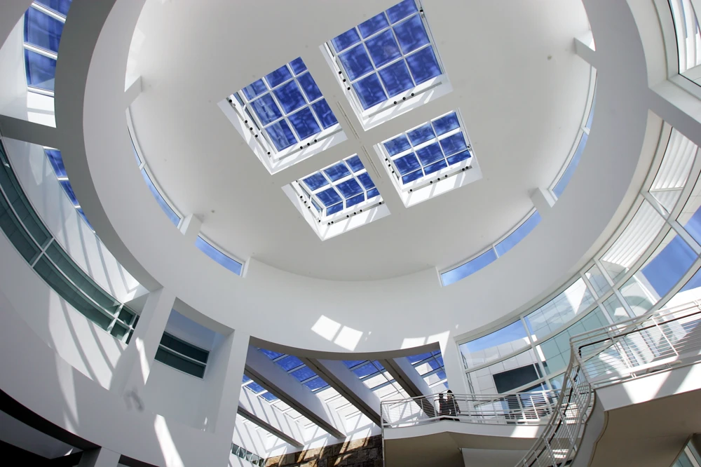Interior view of the Getty Center with the stairs and glass windows on the ceiling.