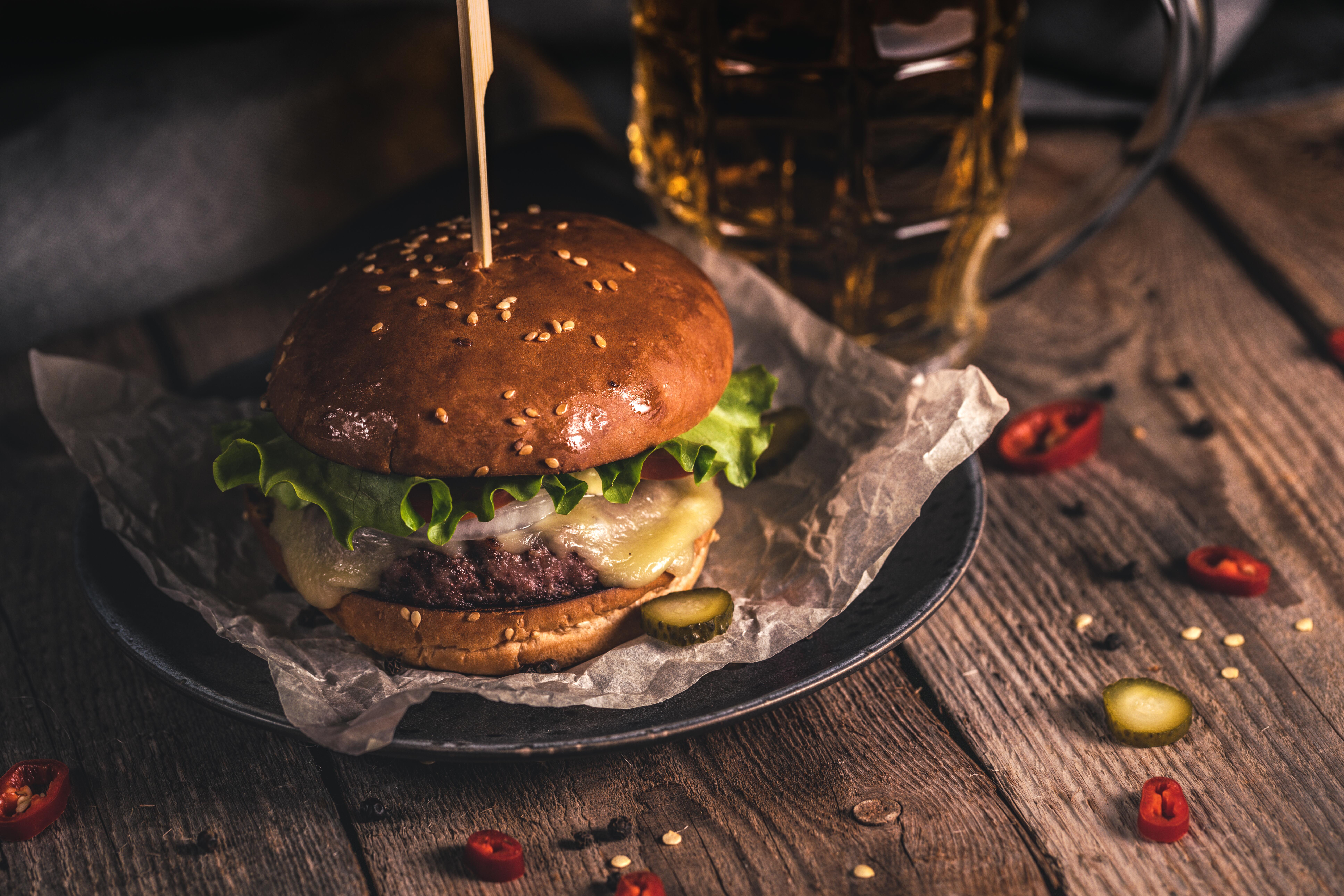 hamburger and beer on table with fries