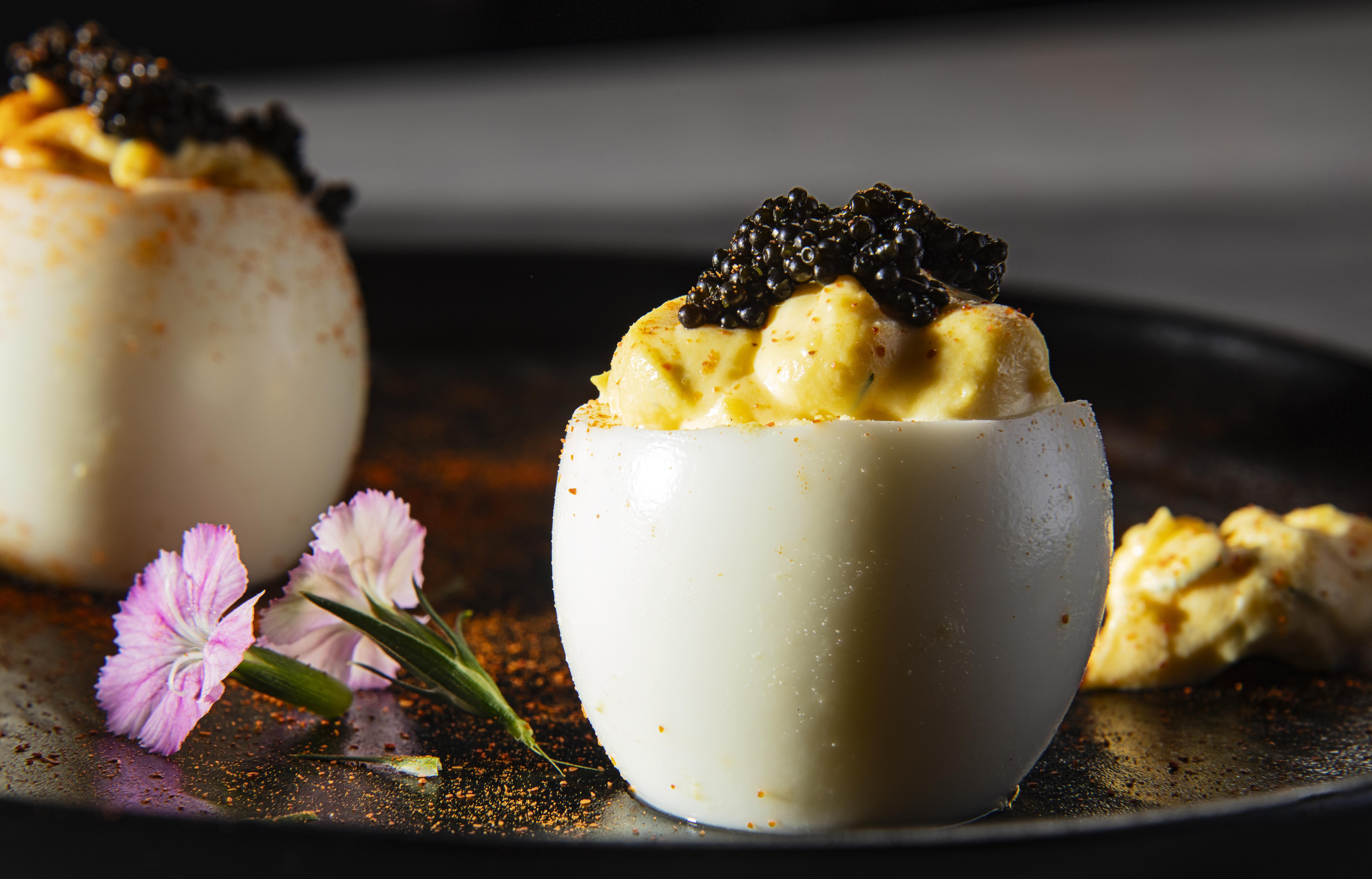 Deviled eggs topped with black caviar