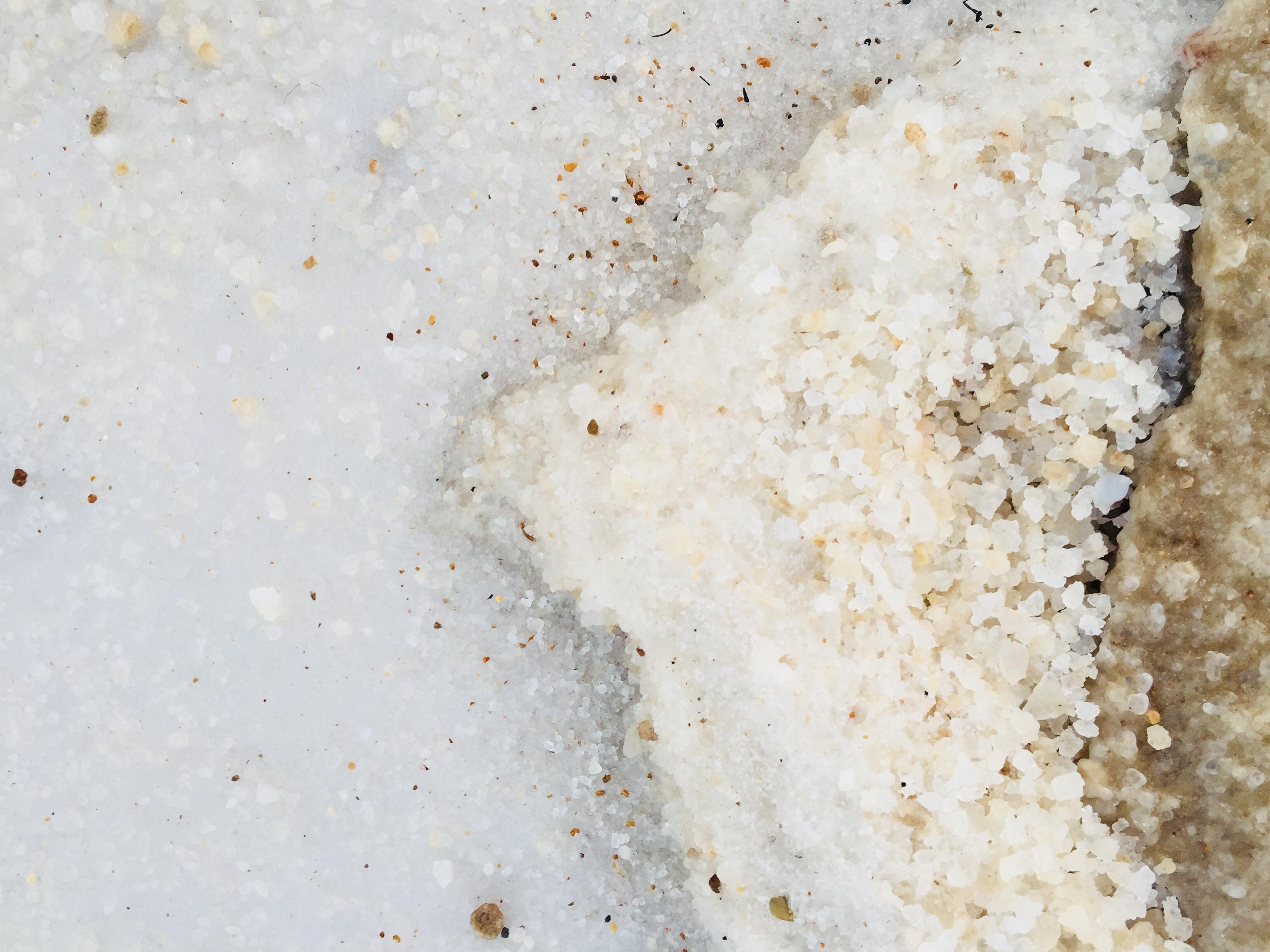 Close-up image of grains on salt from a beach shore.