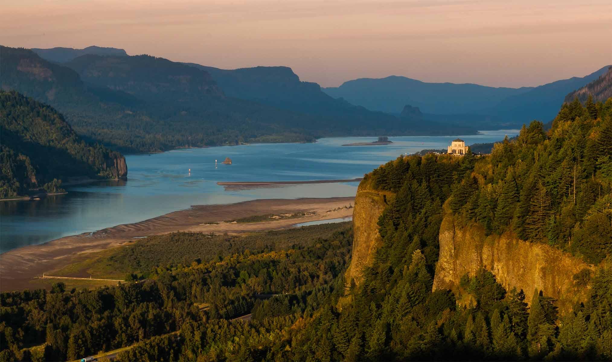 A wide shot of the Columbia River Gorge at sunset