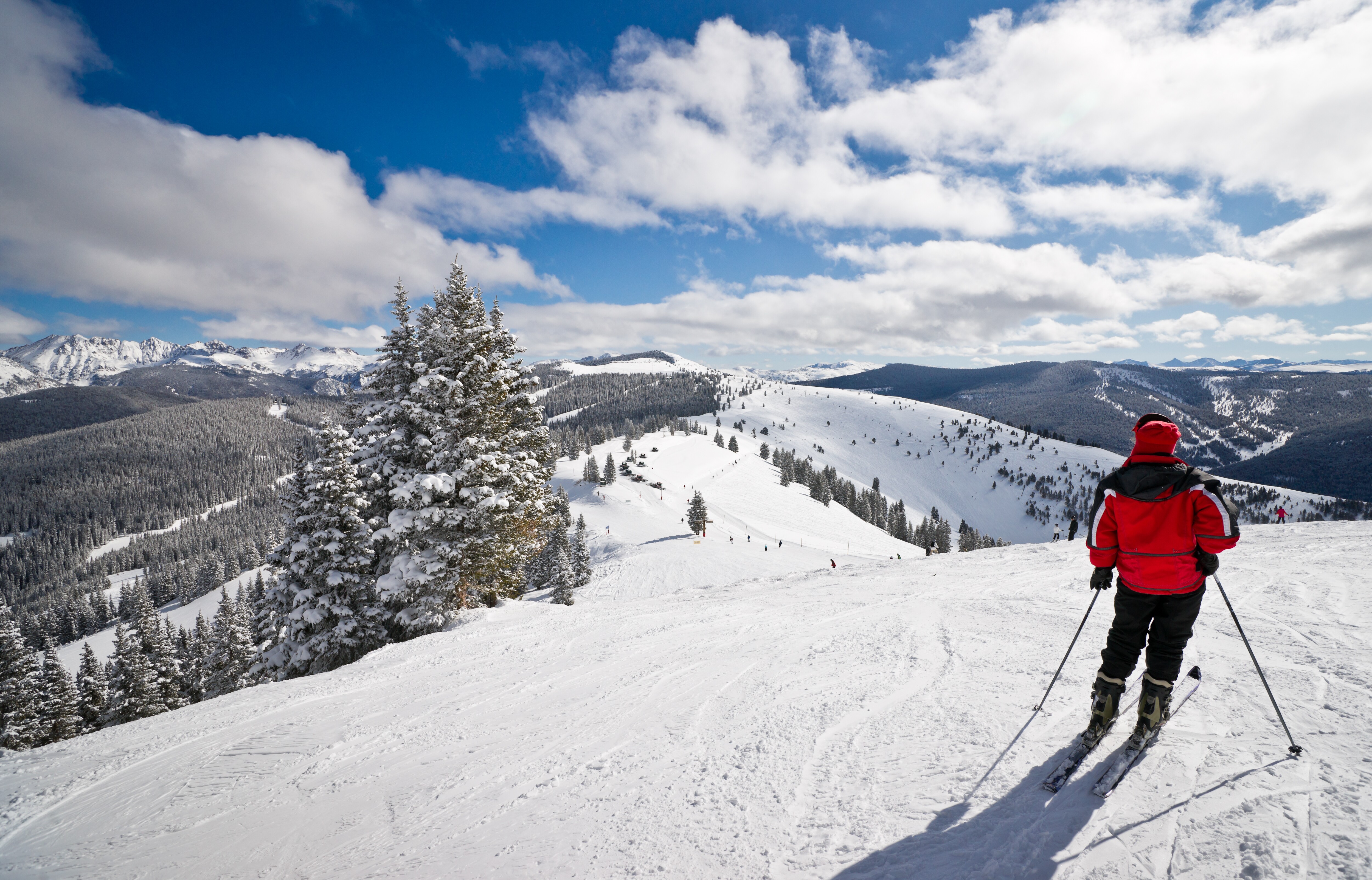 Image of a skier on top of the mountains of Vail, Colorado.