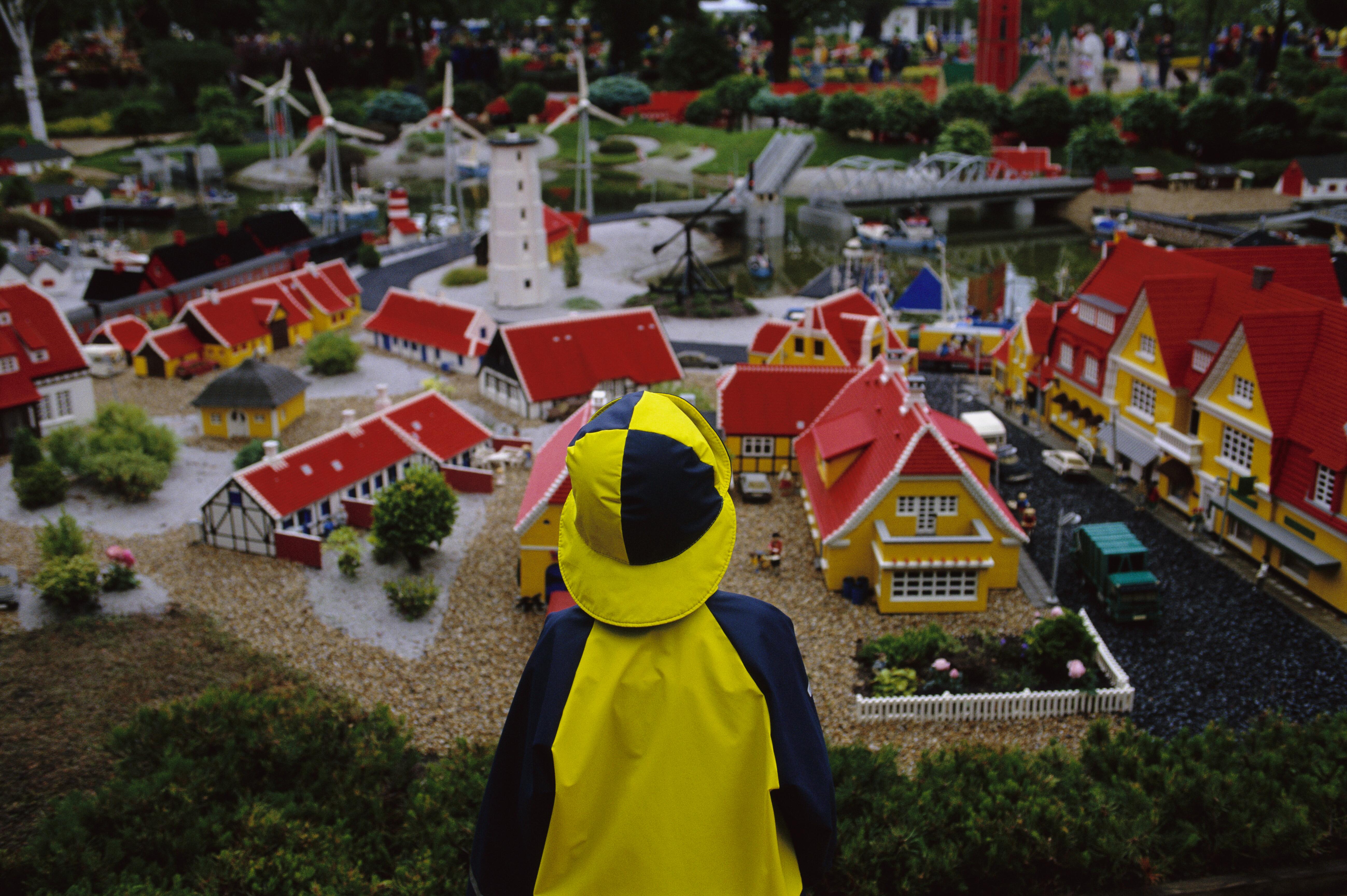Image of a child looking over a Lego model of a city at Legoland.