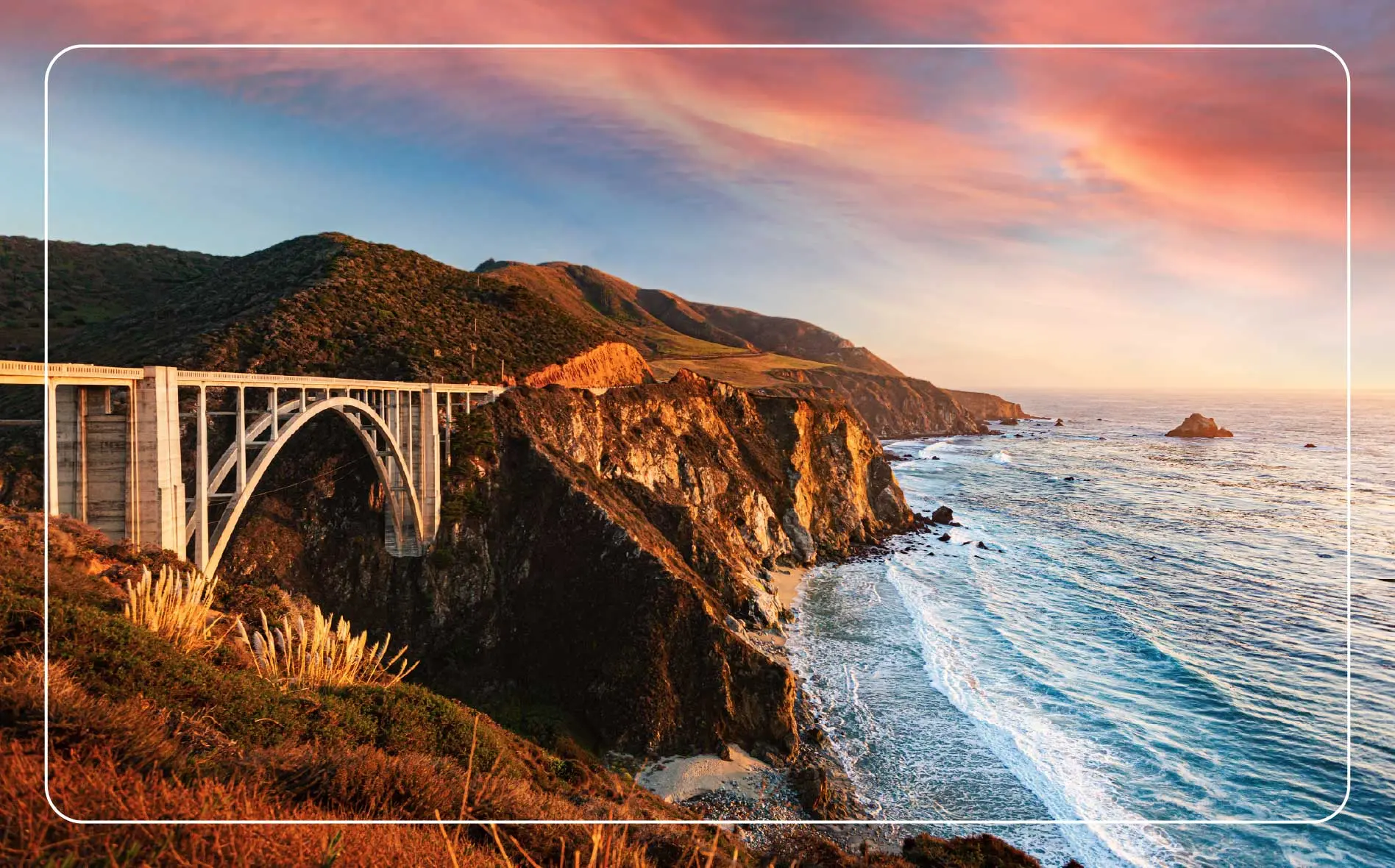 The Big Sur highway winds through the hills along the shore.