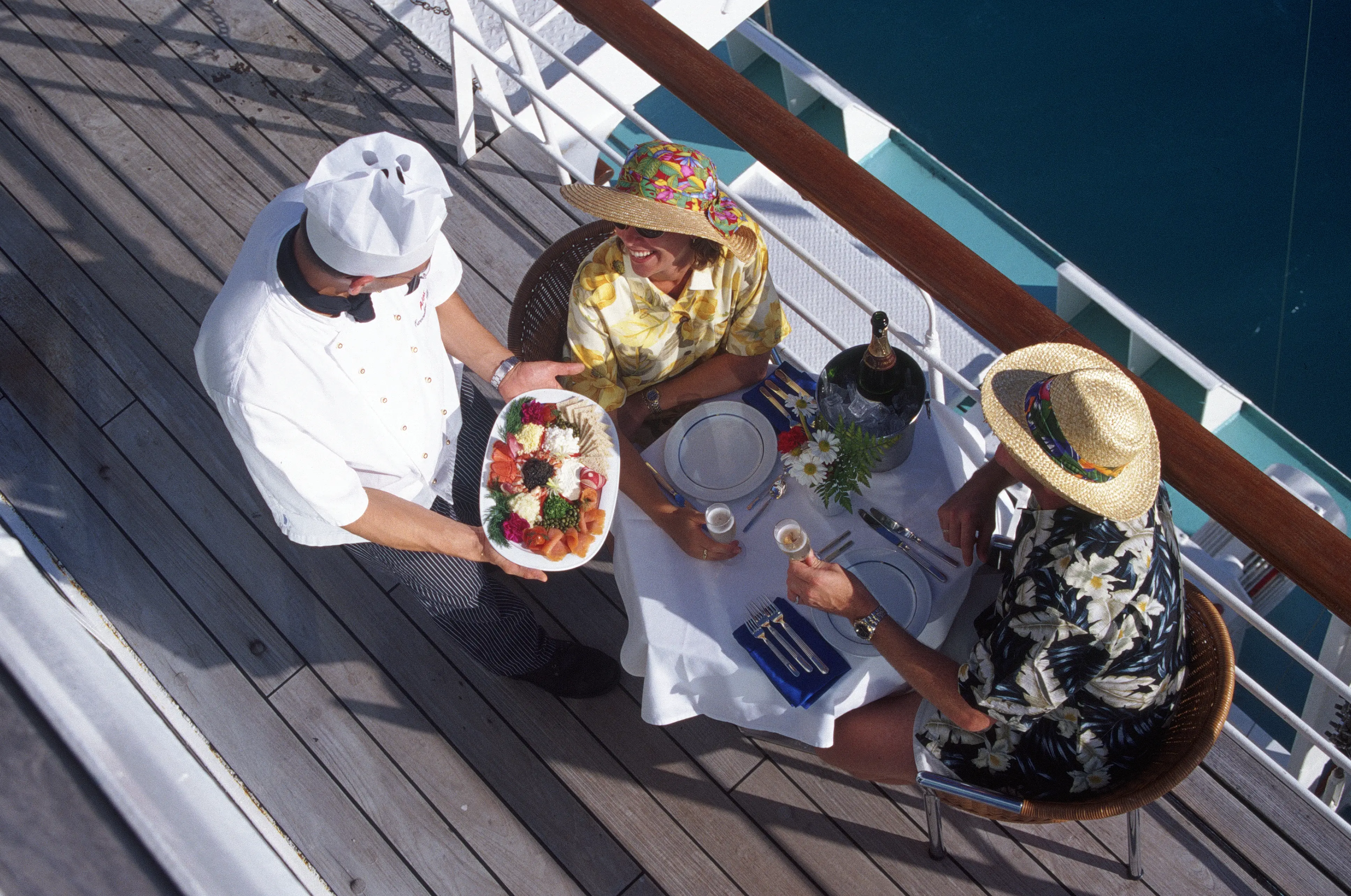 Overhead image of a couple eating together on a cruise ship.
