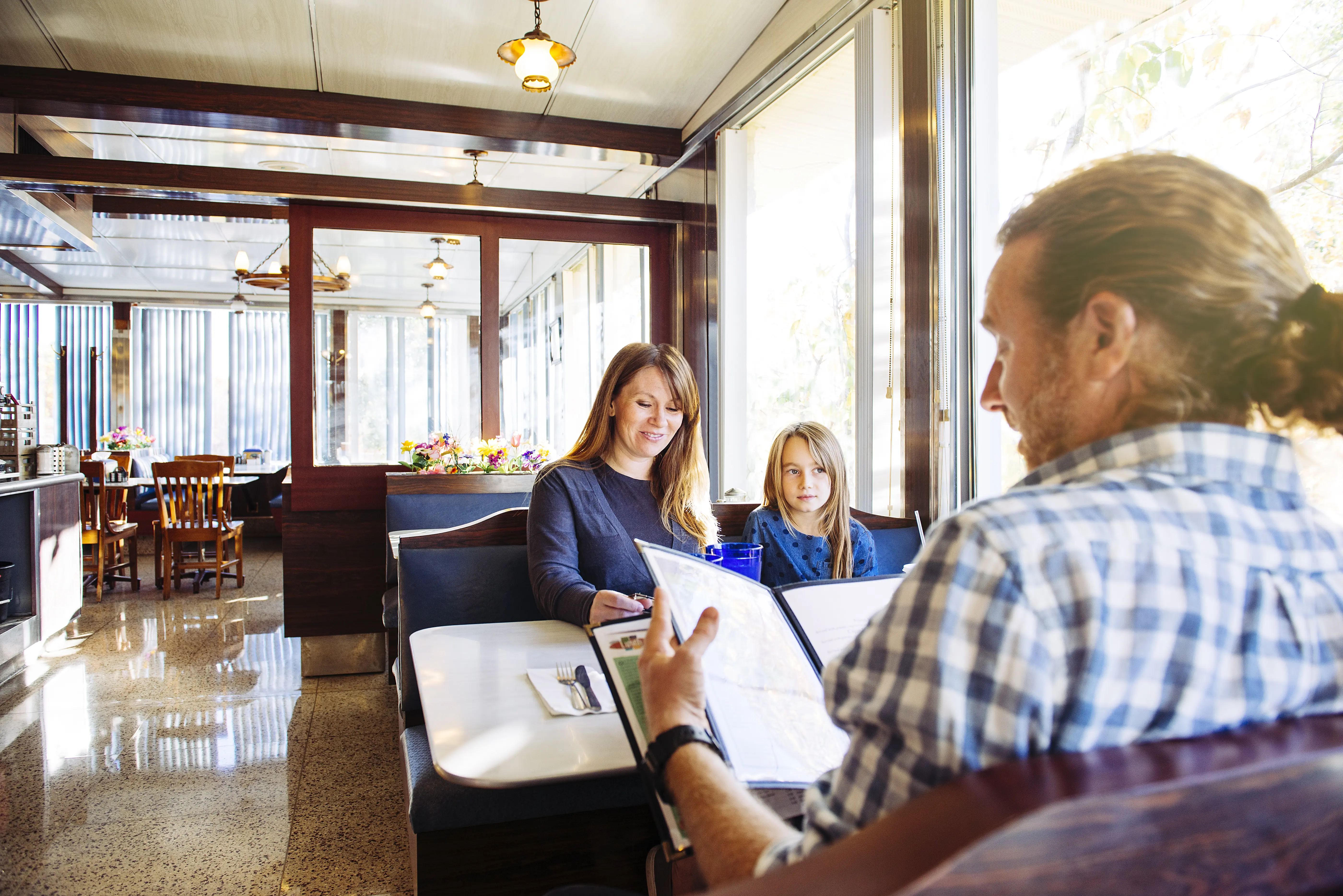 Interior shot of a family eating together in a restaurant.