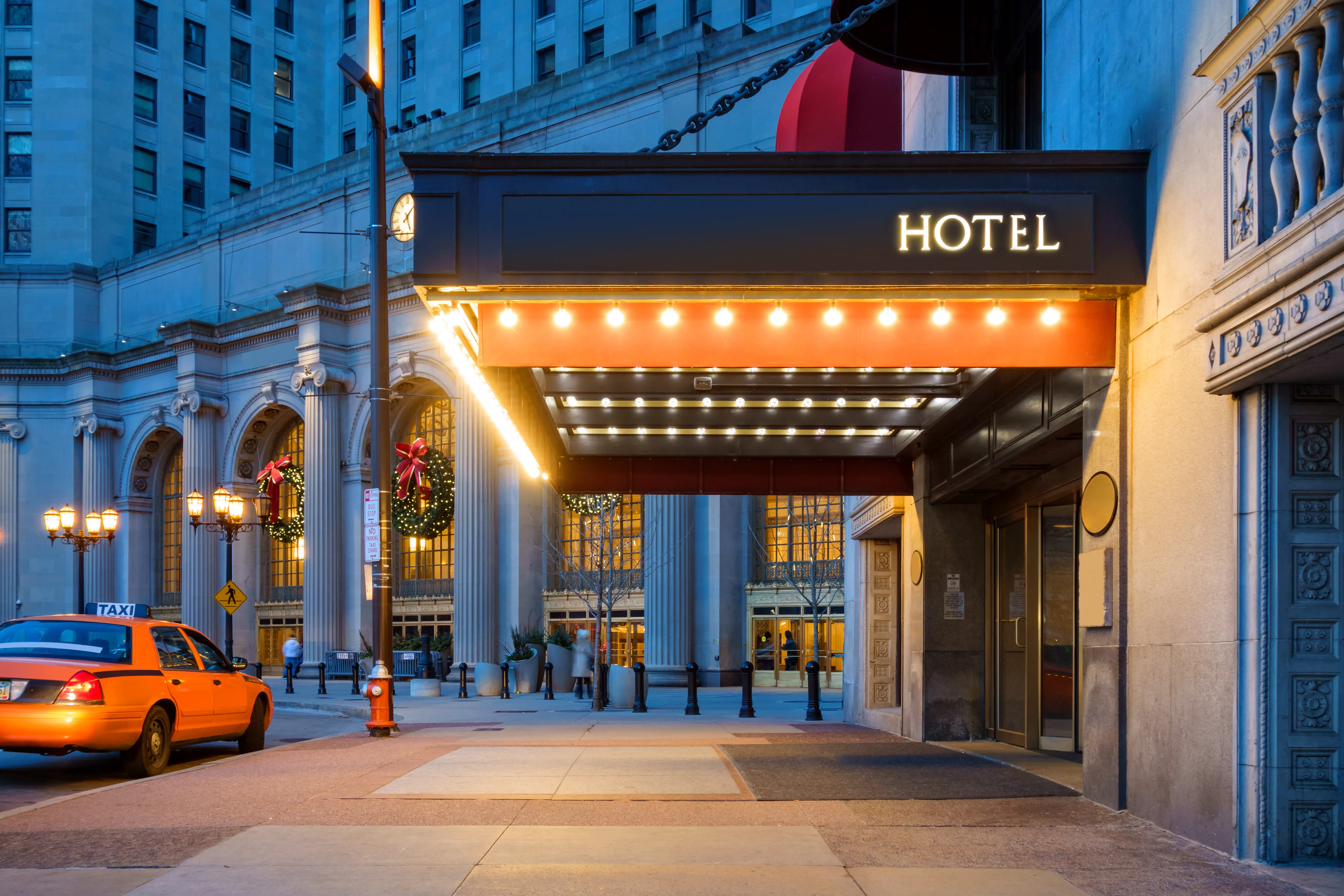 Hotel entrance and a waiting taxi cab in downtown Cleveland during the winter holidays