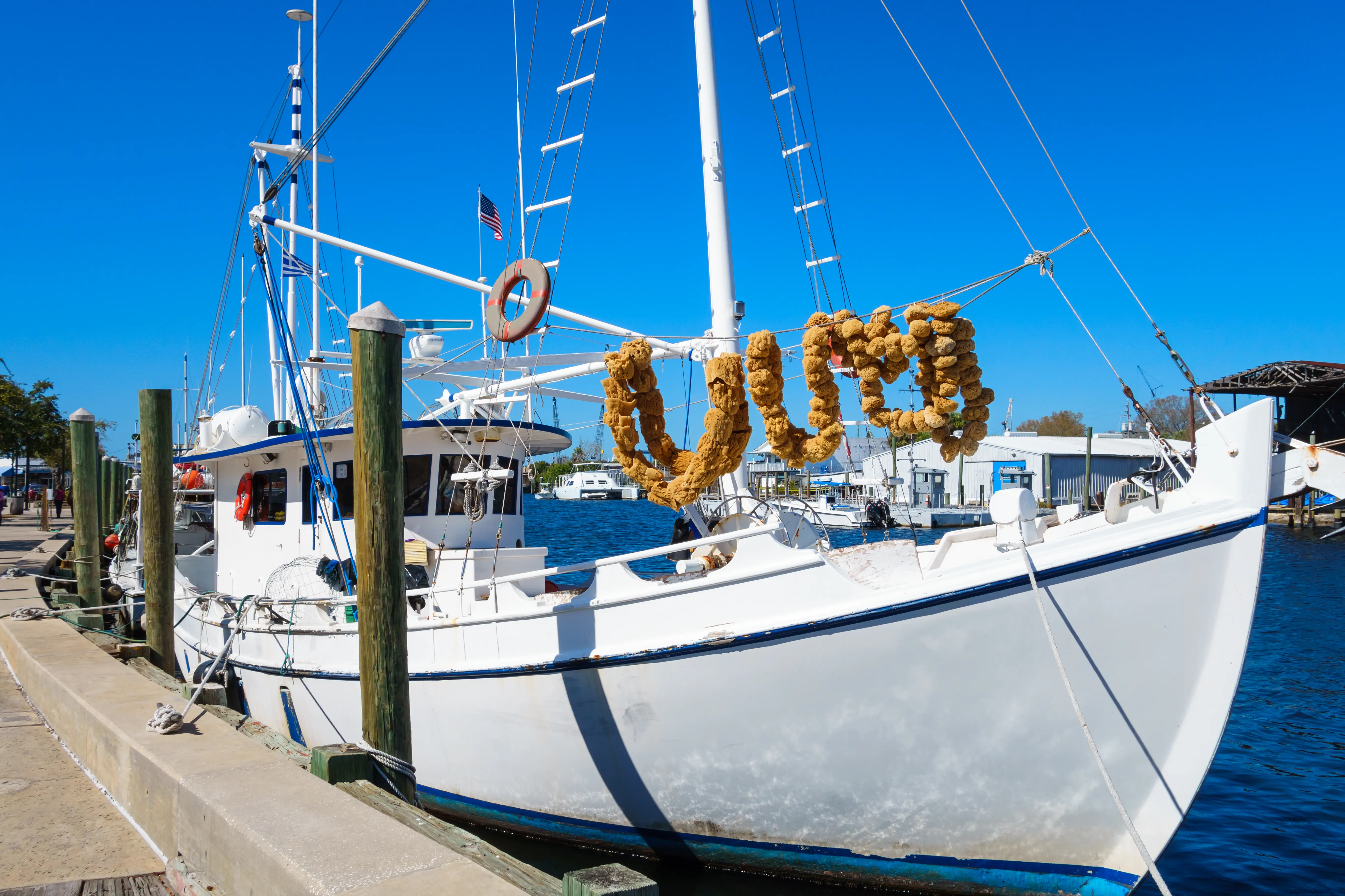 Boat decorated with sponges docked at the Sponge Docks in Tarpon Springs, Florida, USA