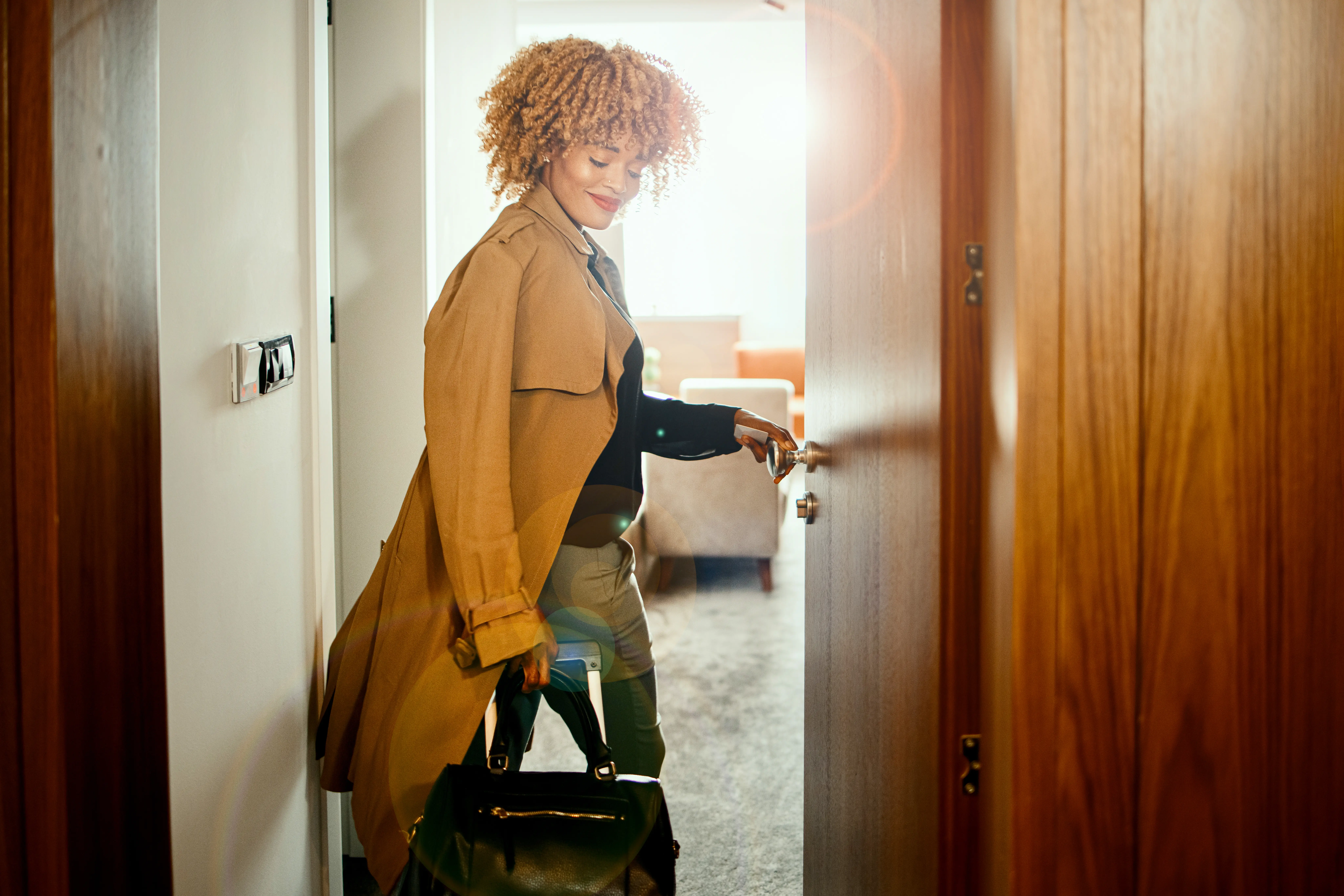 Trendy young woman entering her hotel room