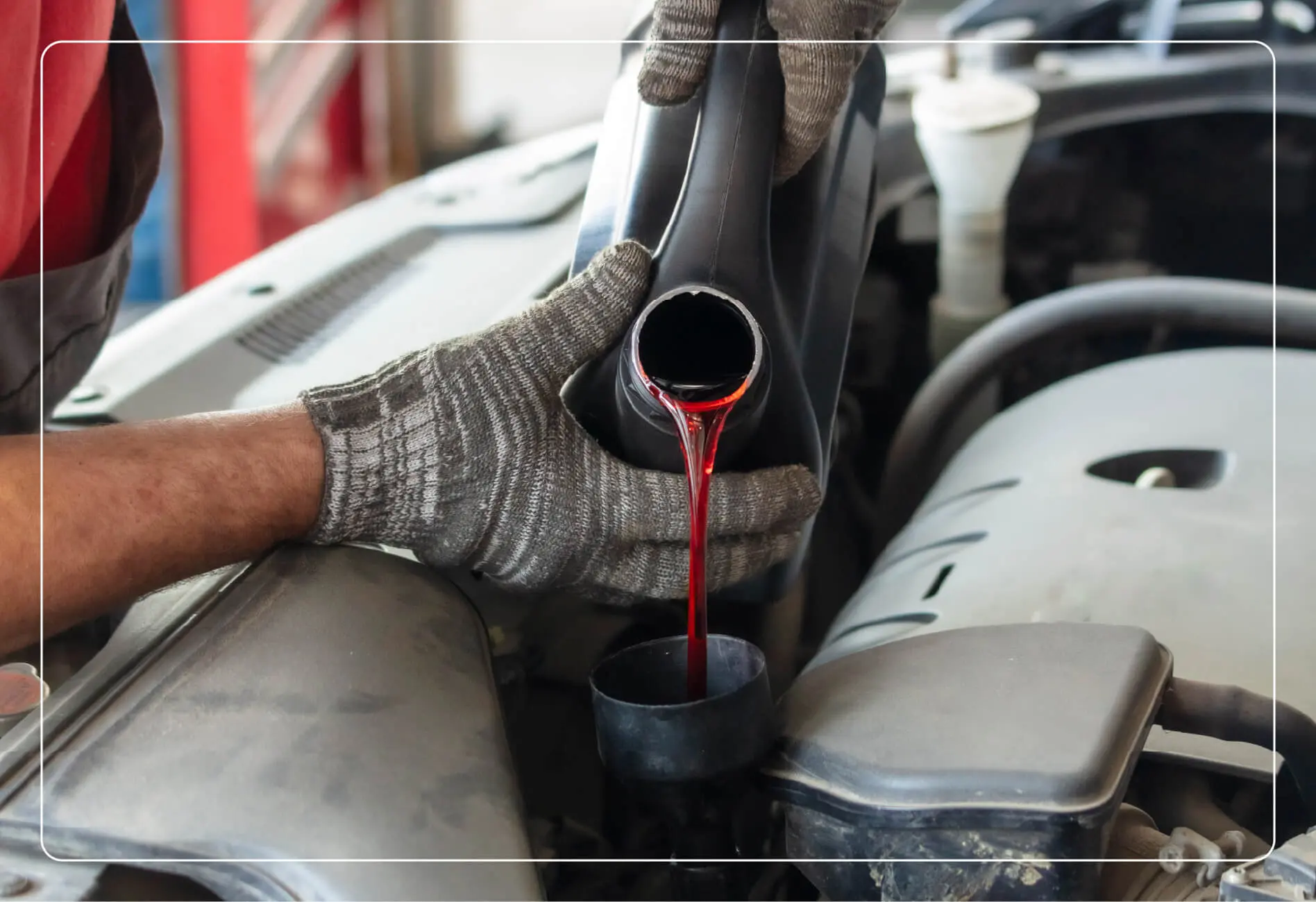 mechanic pouring transmission fluid