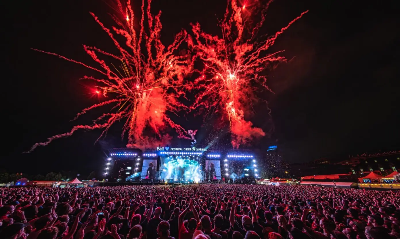 Image of the crowds at a performance for the Bell stage at the Quebec City Summer Festival in 2024.