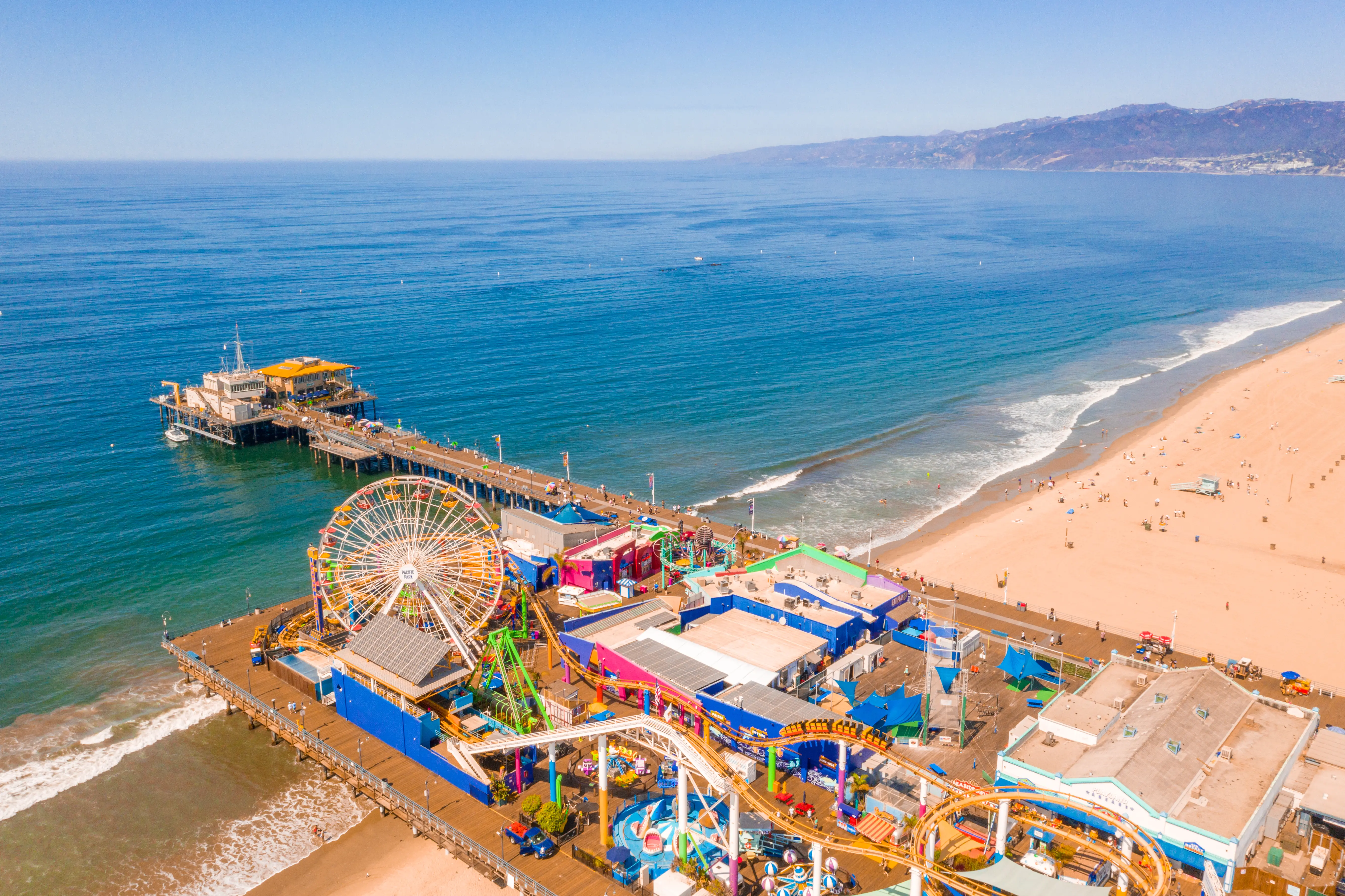 Aerial view of Santa Monica Pier, amusement park with ferris wheel and roller coaster, California