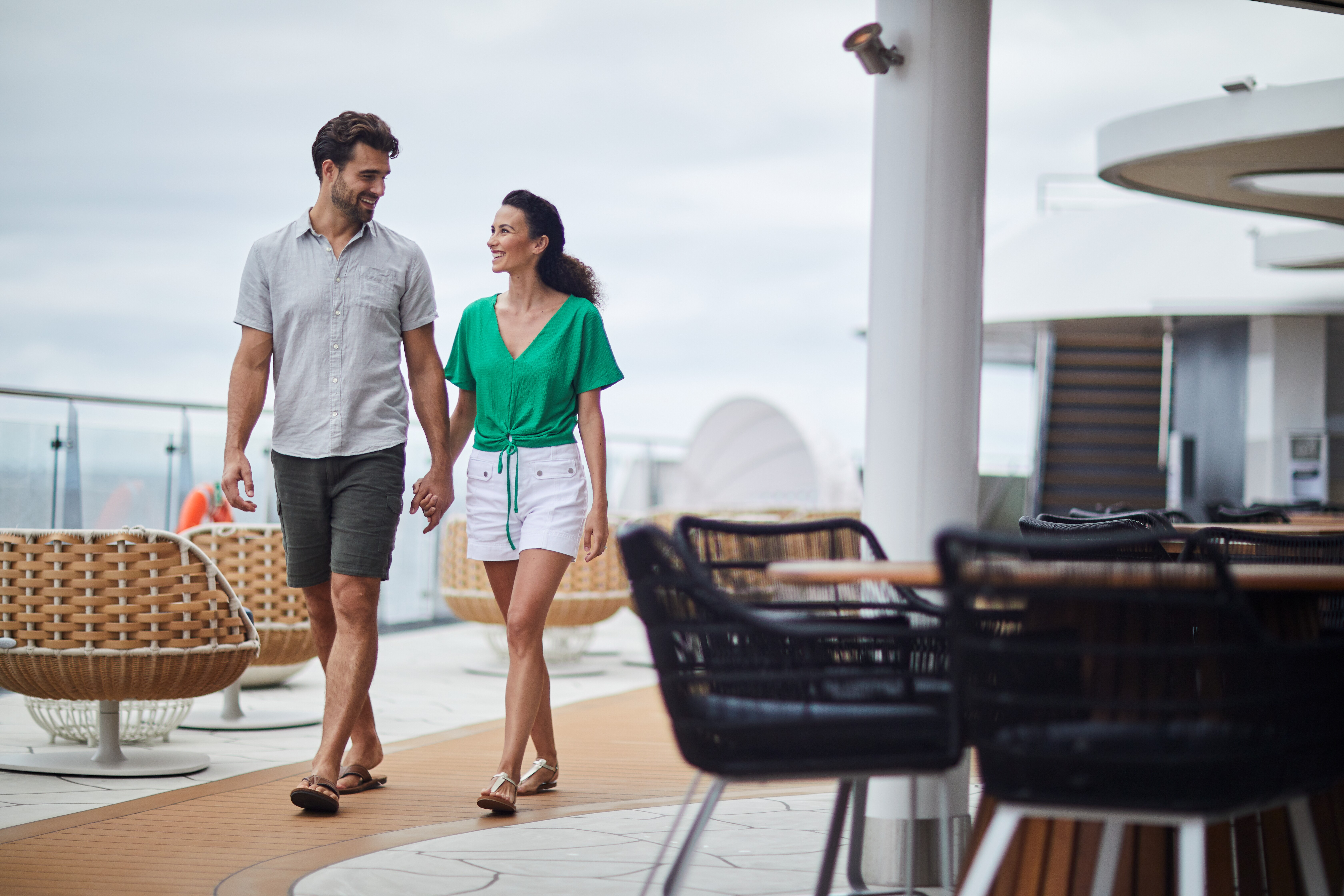 Couple walking on top deck of Celebrity Cruises