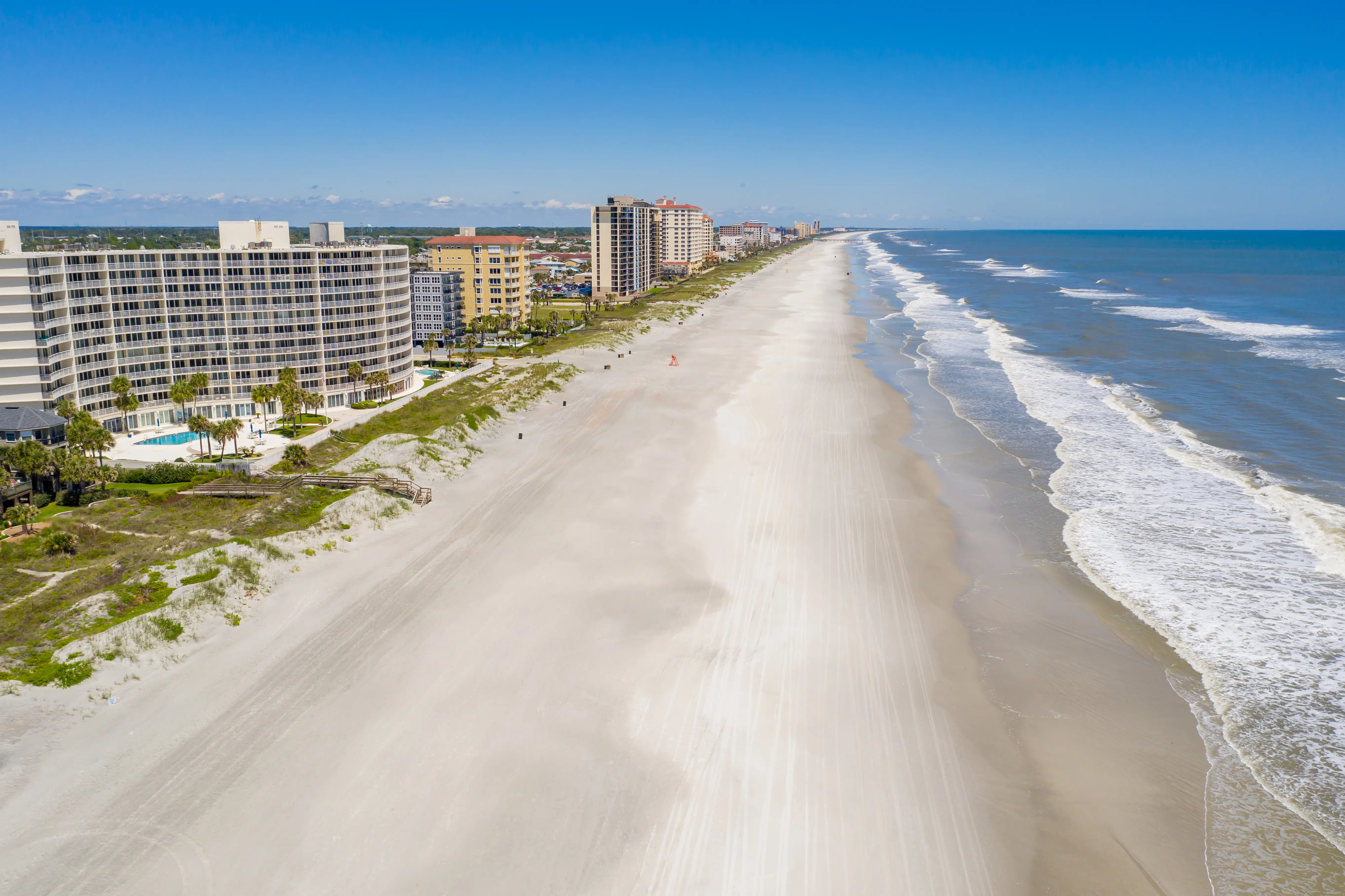 View of clean empty beach coastline and buildings in Jacksonville, Florida